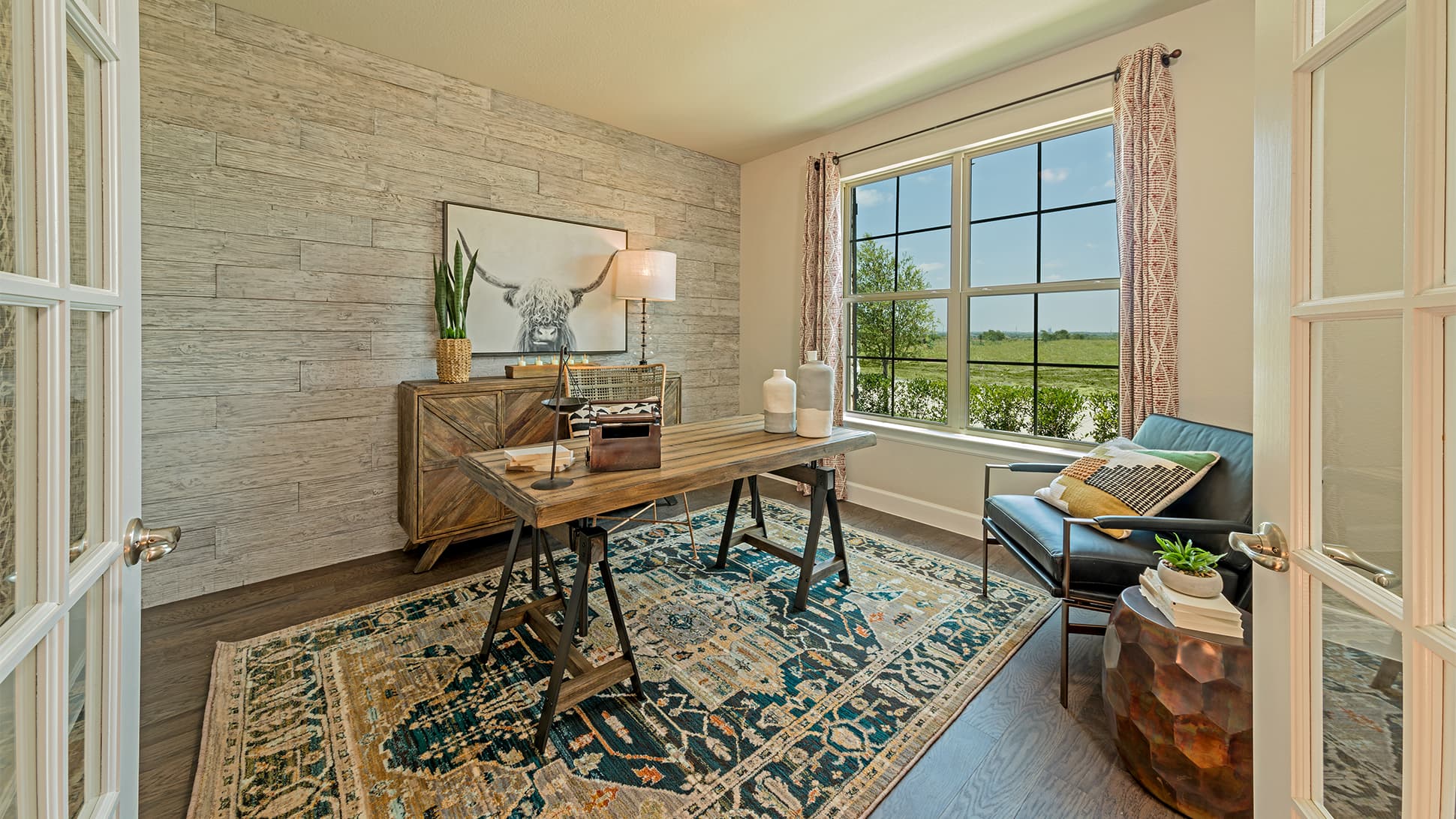 private study with large window and wood floors