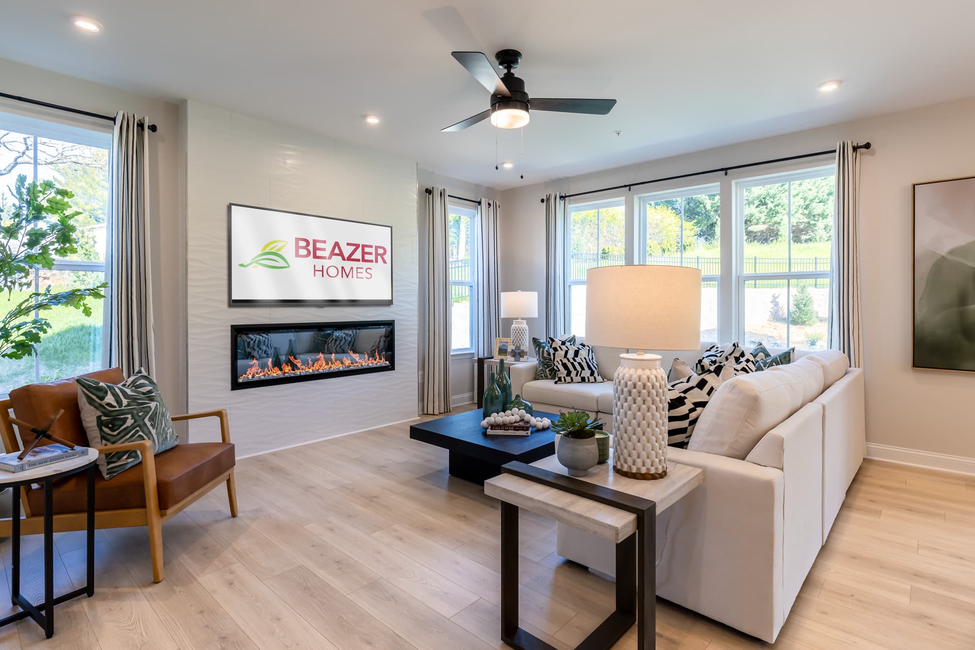 great room with an electric fireplace and couches