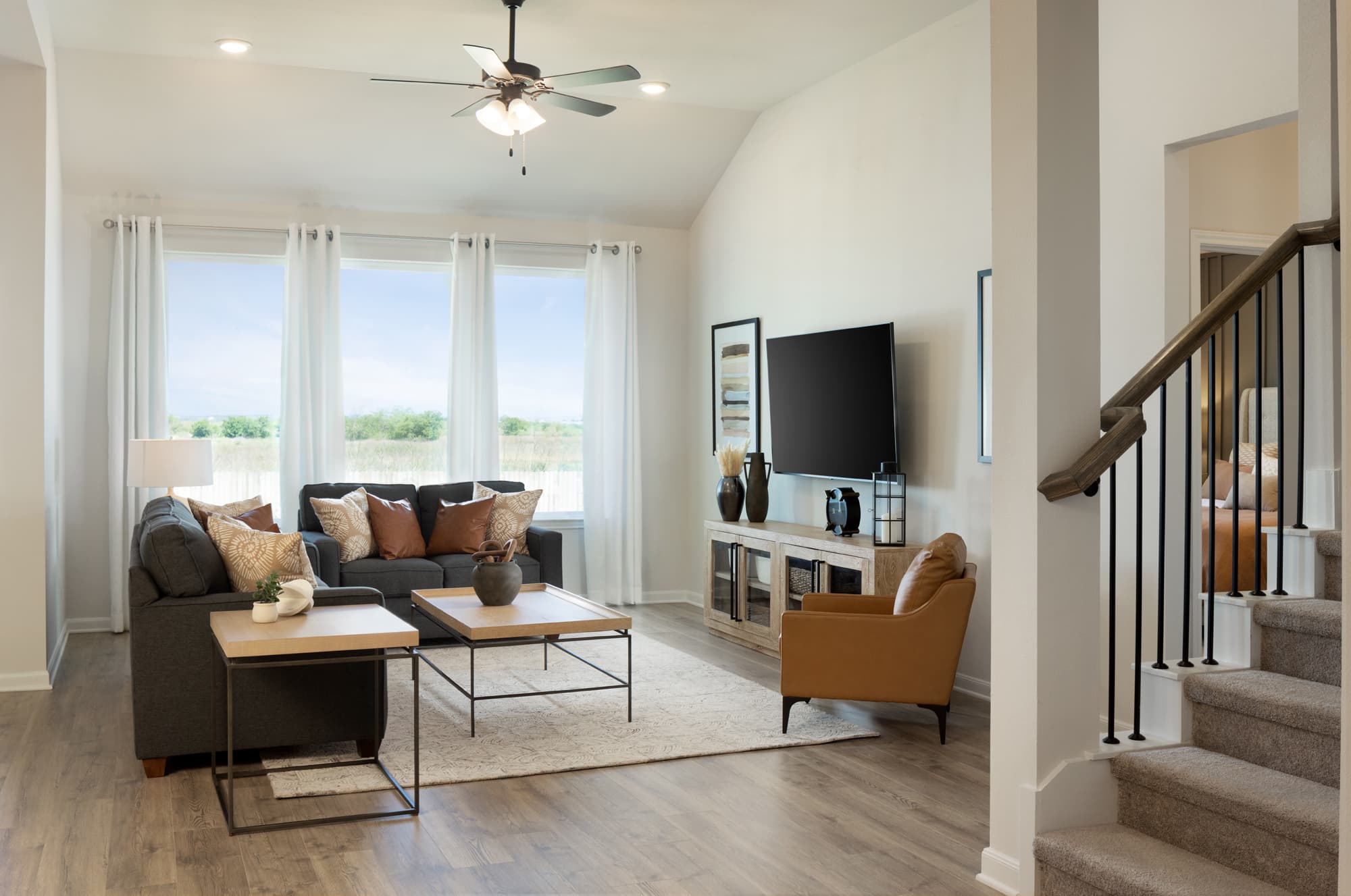living room with grey couches and large windows 