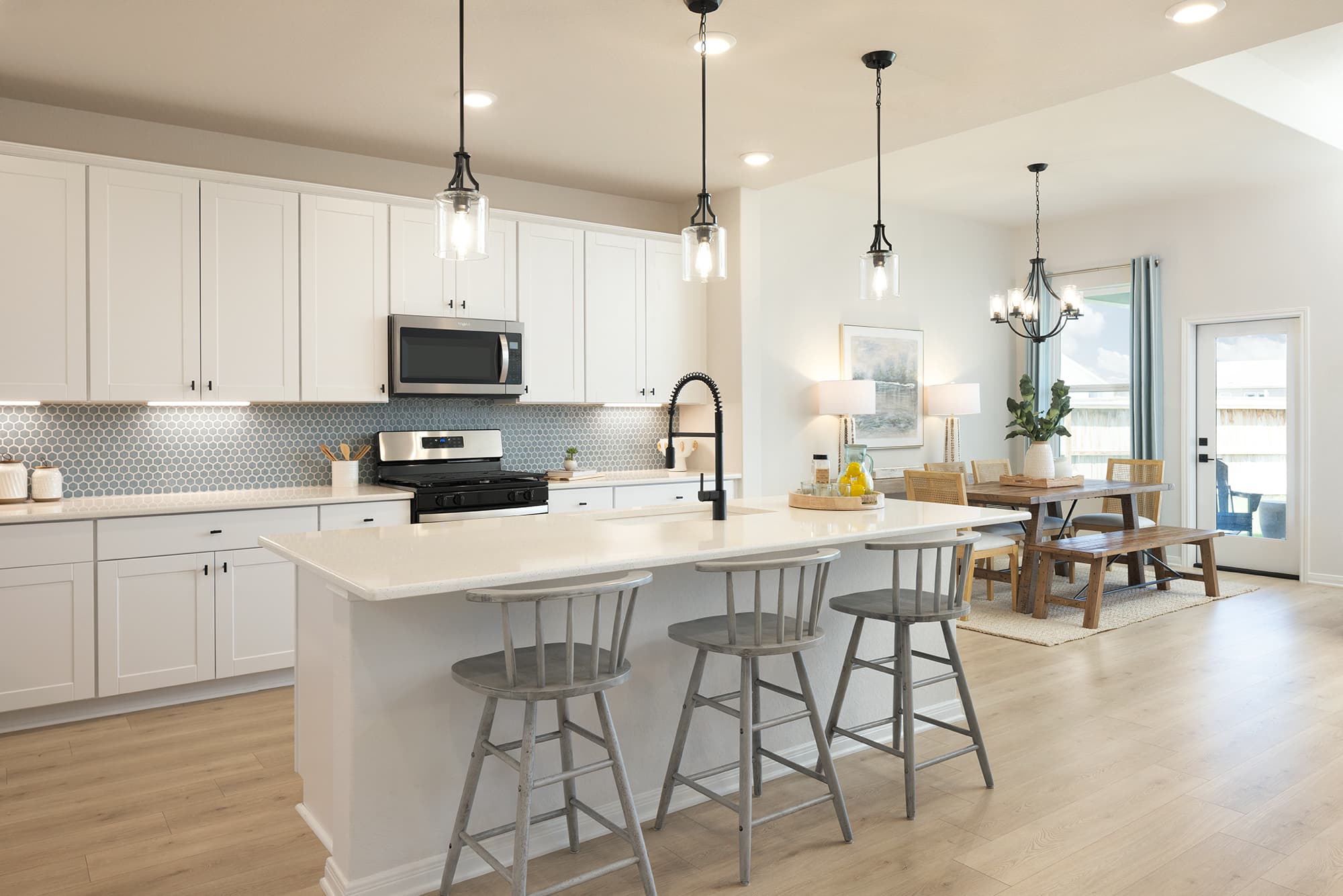 kitchen with white countertops & barstools