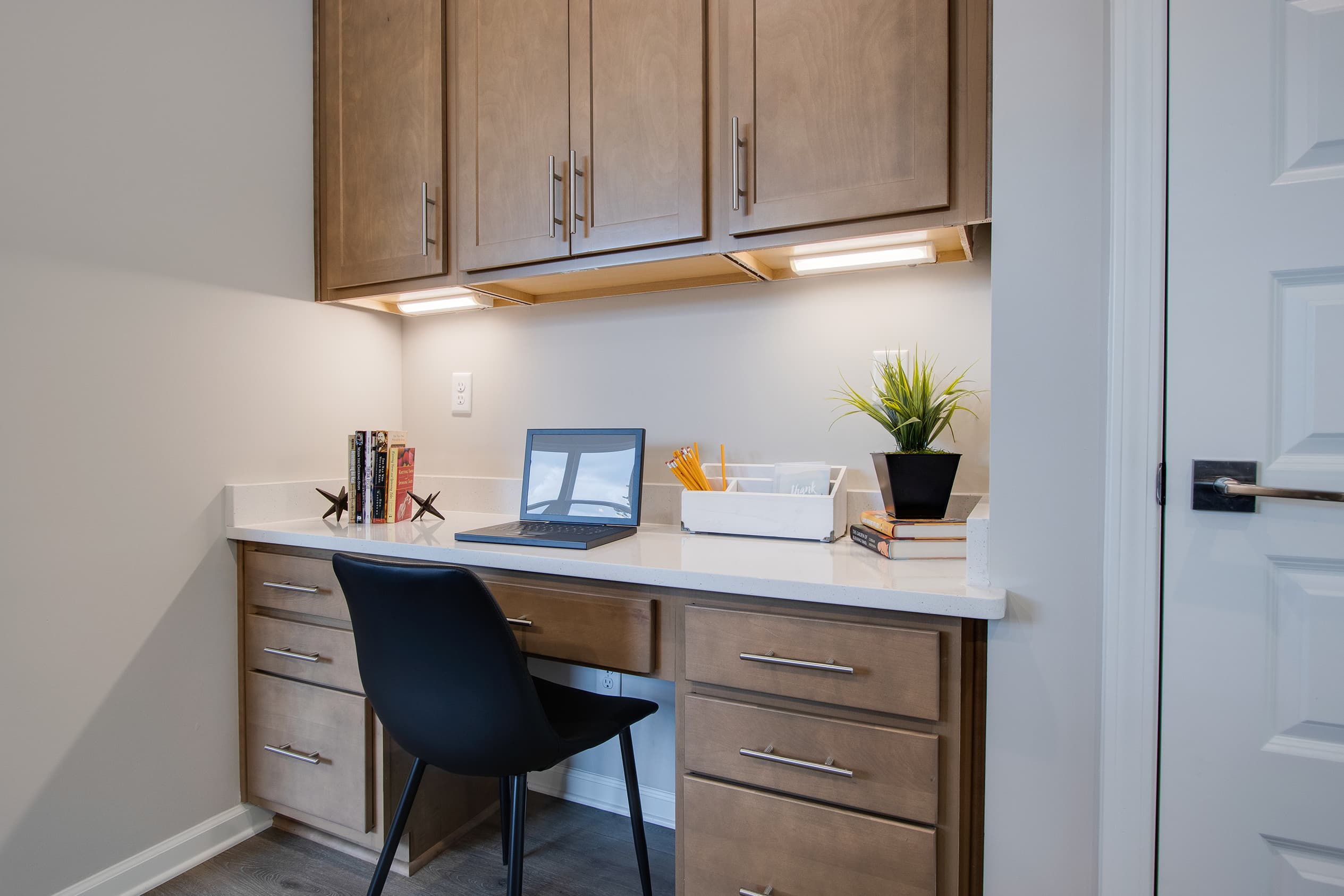 home office desk setup next to kitchen area