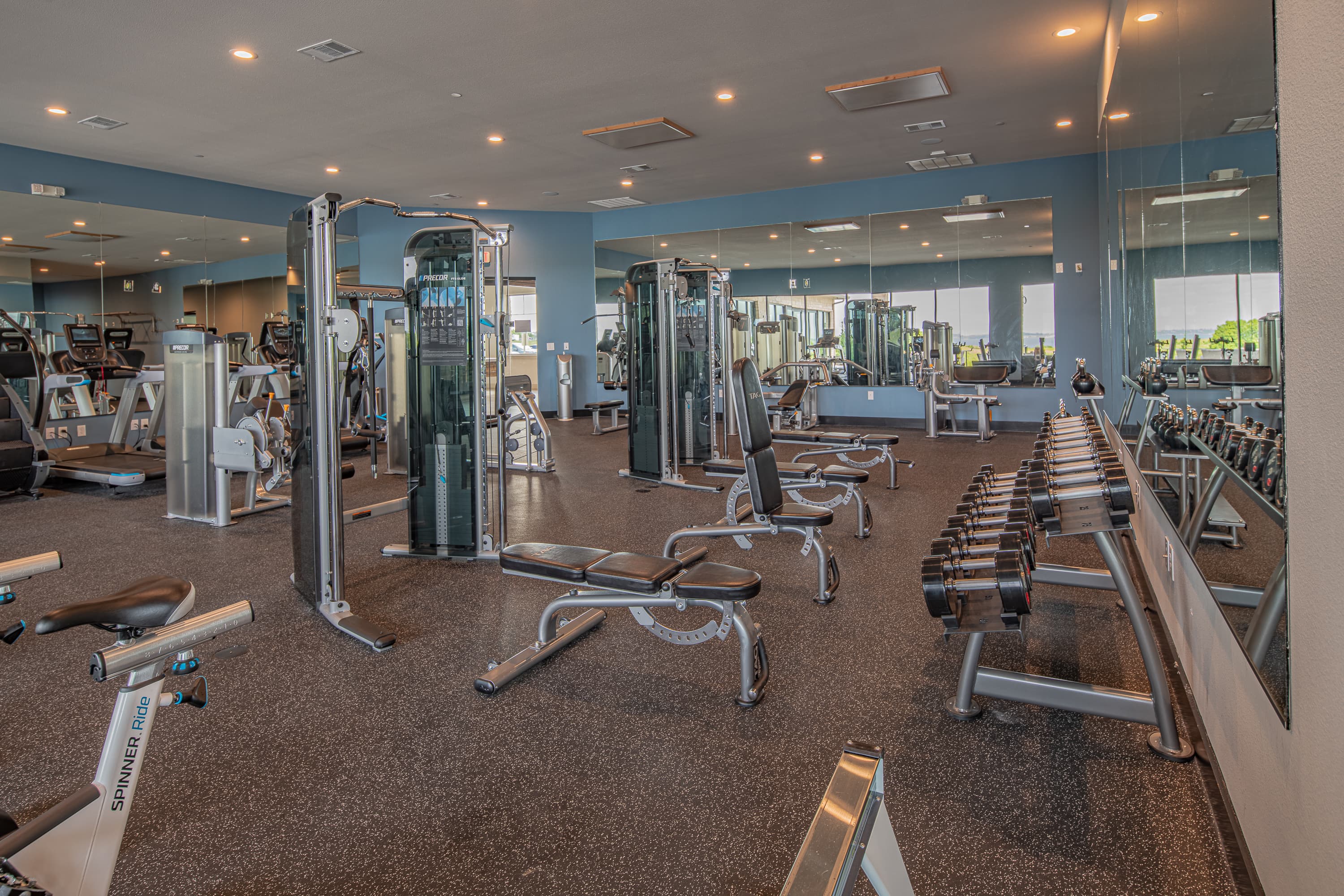 fitness center with gym equipment and windows