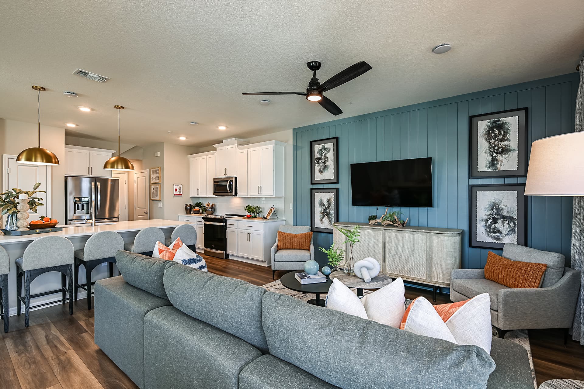 great room with grey couch and accent wall