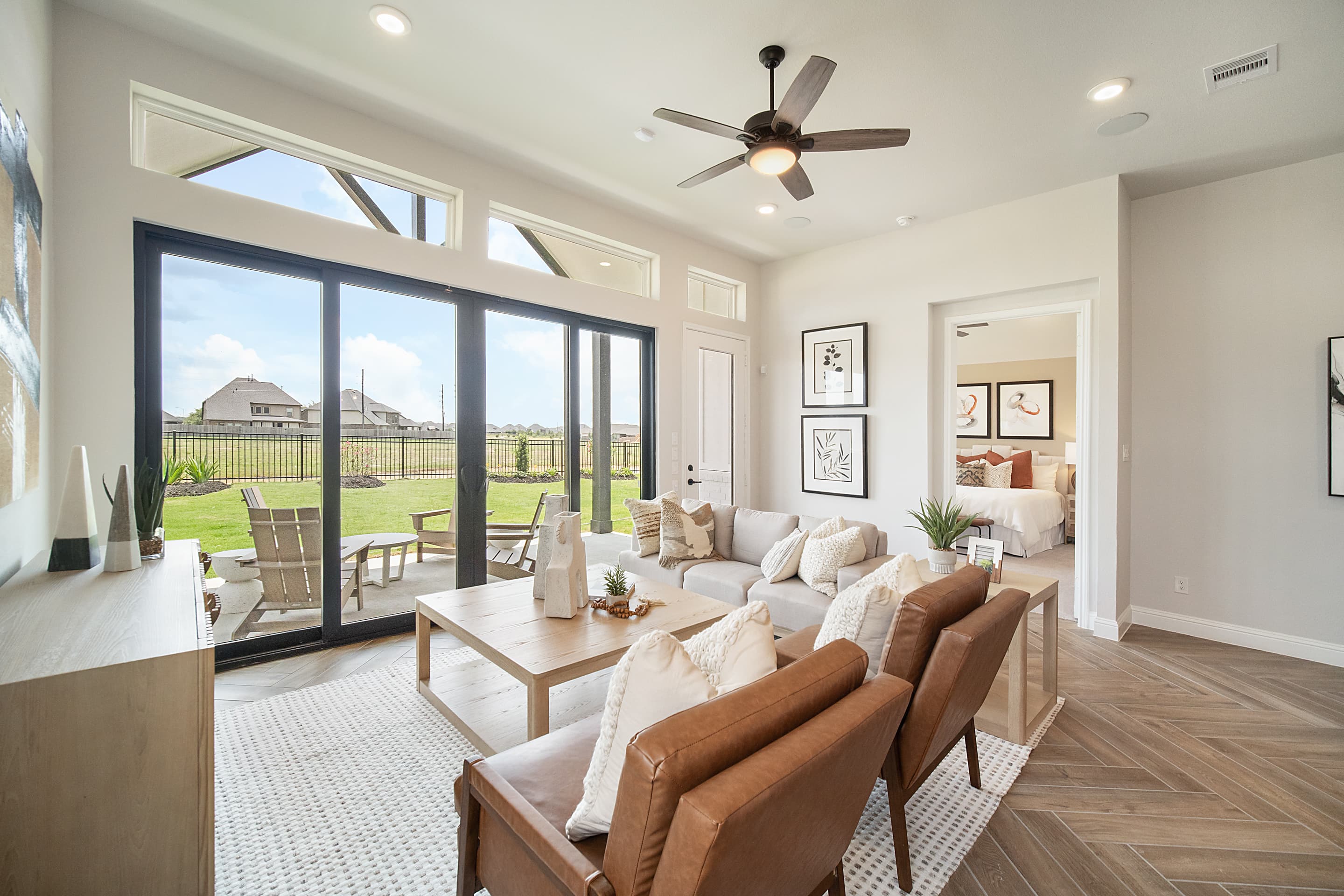 great room with sliding glass doors and fan 