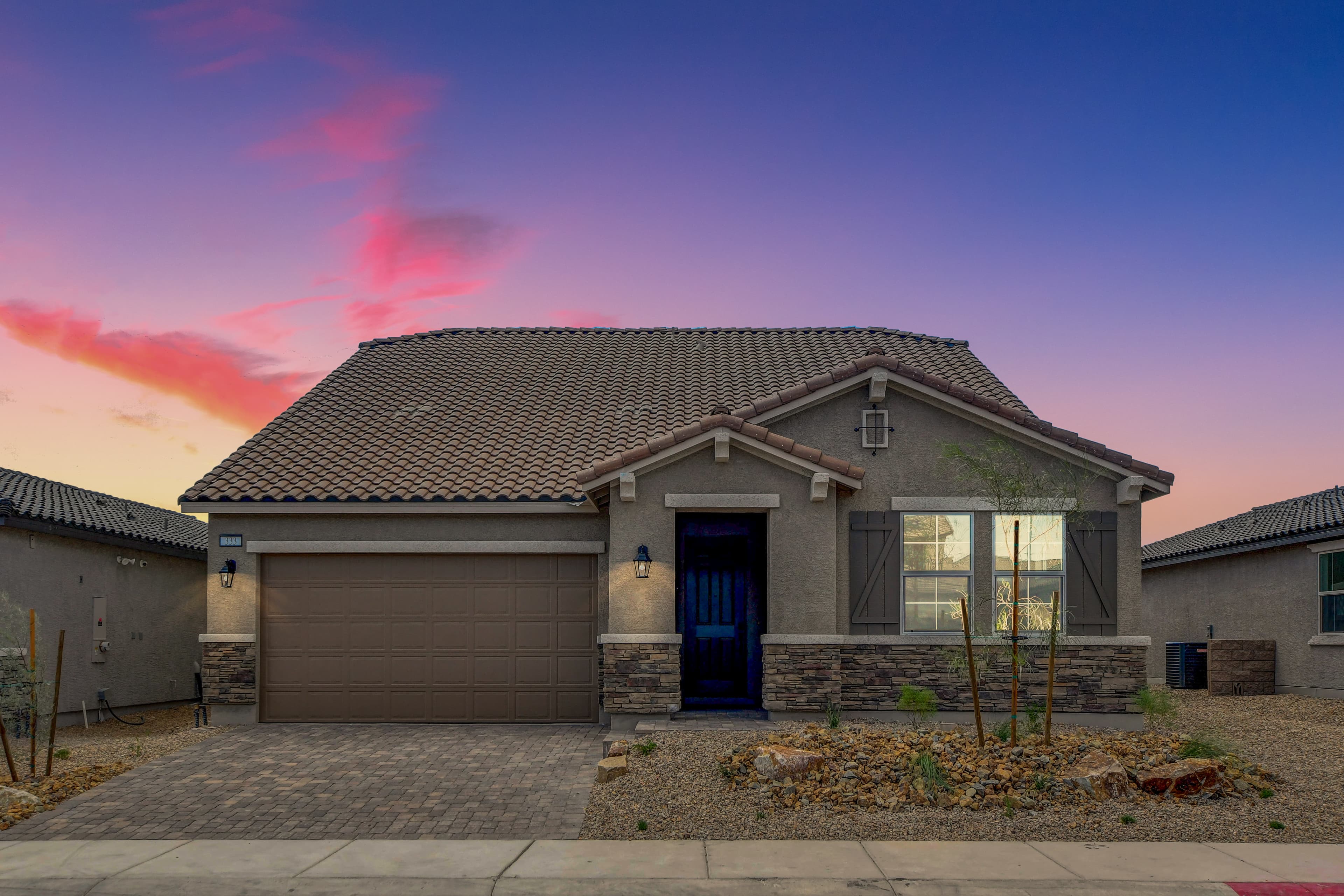 exterior with two-car garage stone driveway