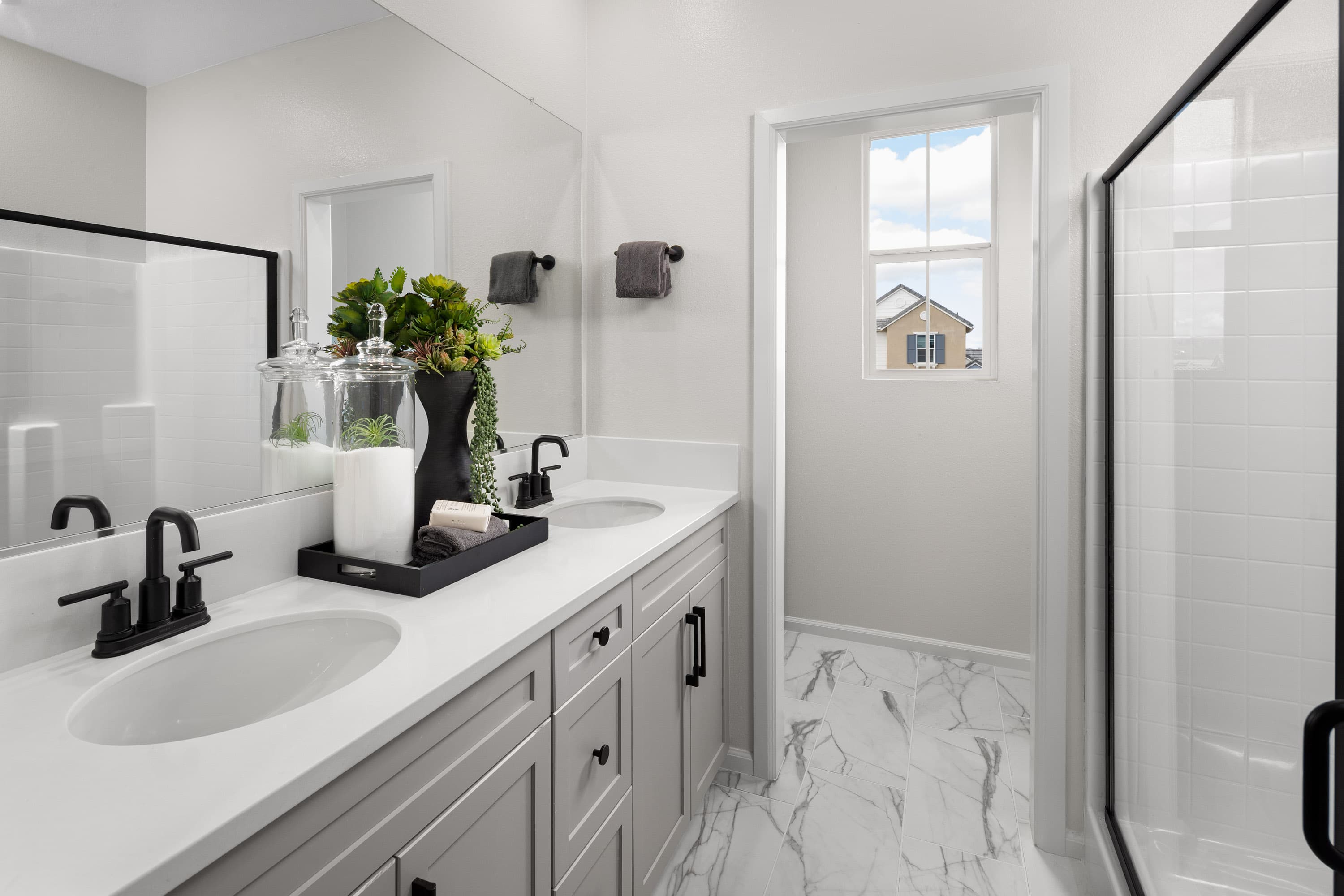 bathroom with tile flooring and gray cabinets