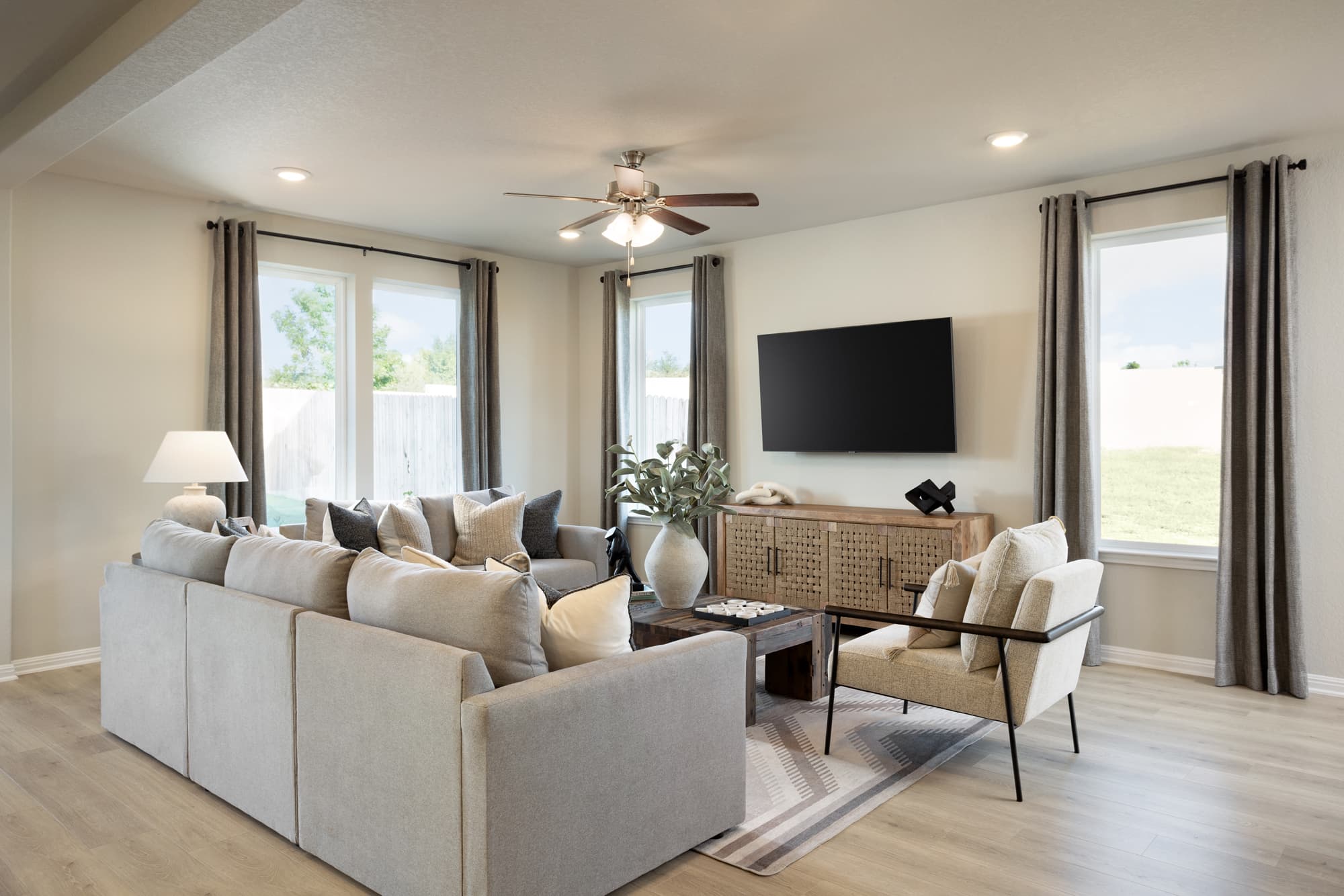 great room with white couches & wood flooring