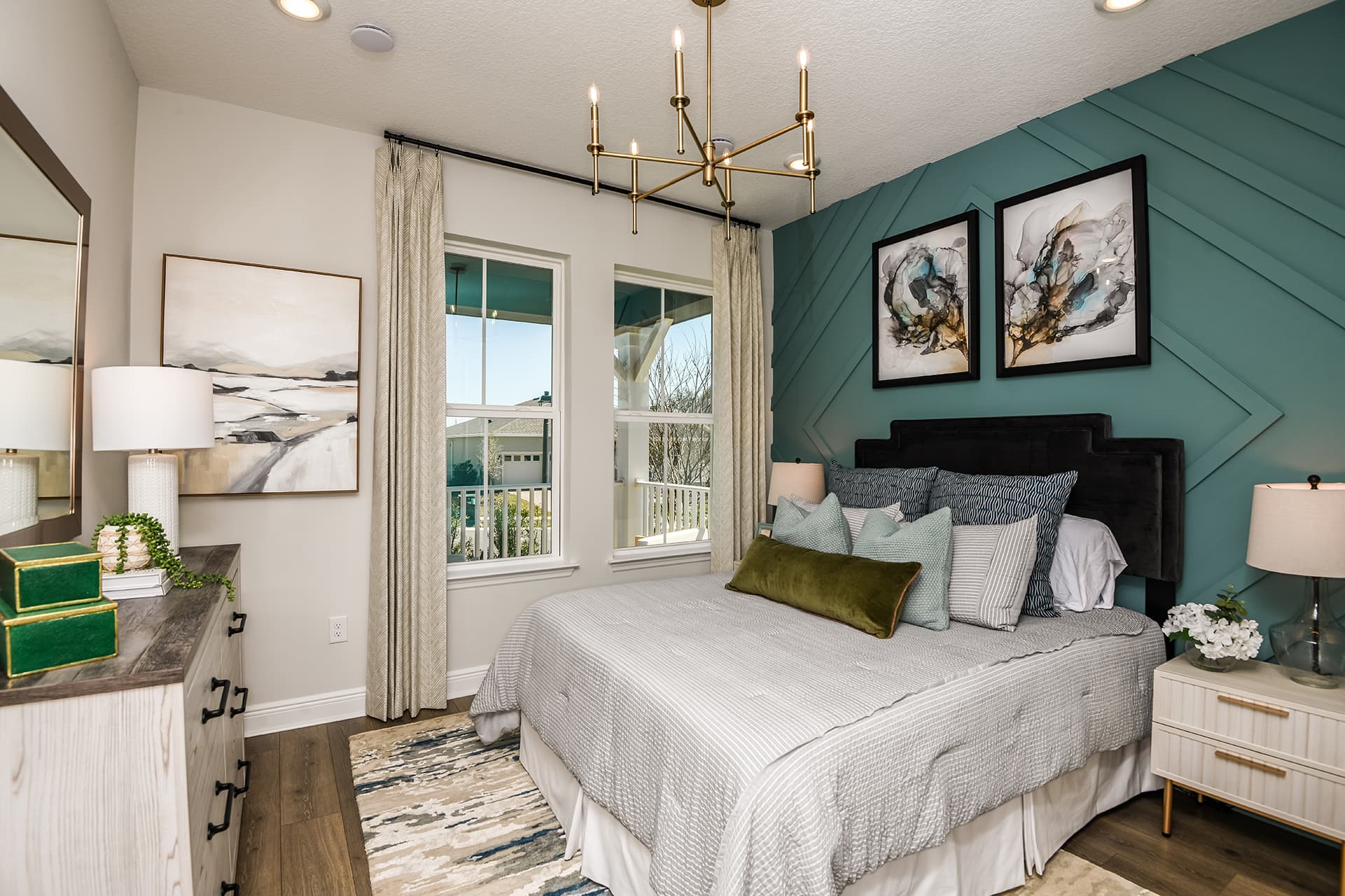 secondary bedroom with accent wall and two windows