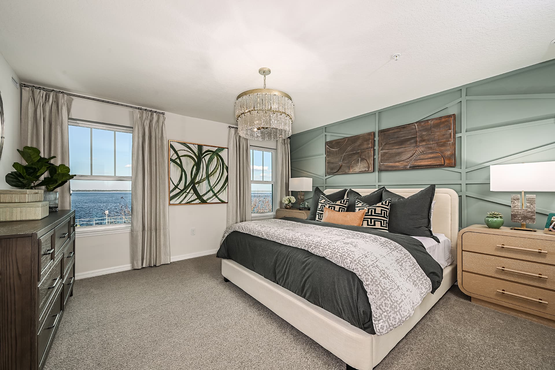 primary bedroom with white bed and carpet