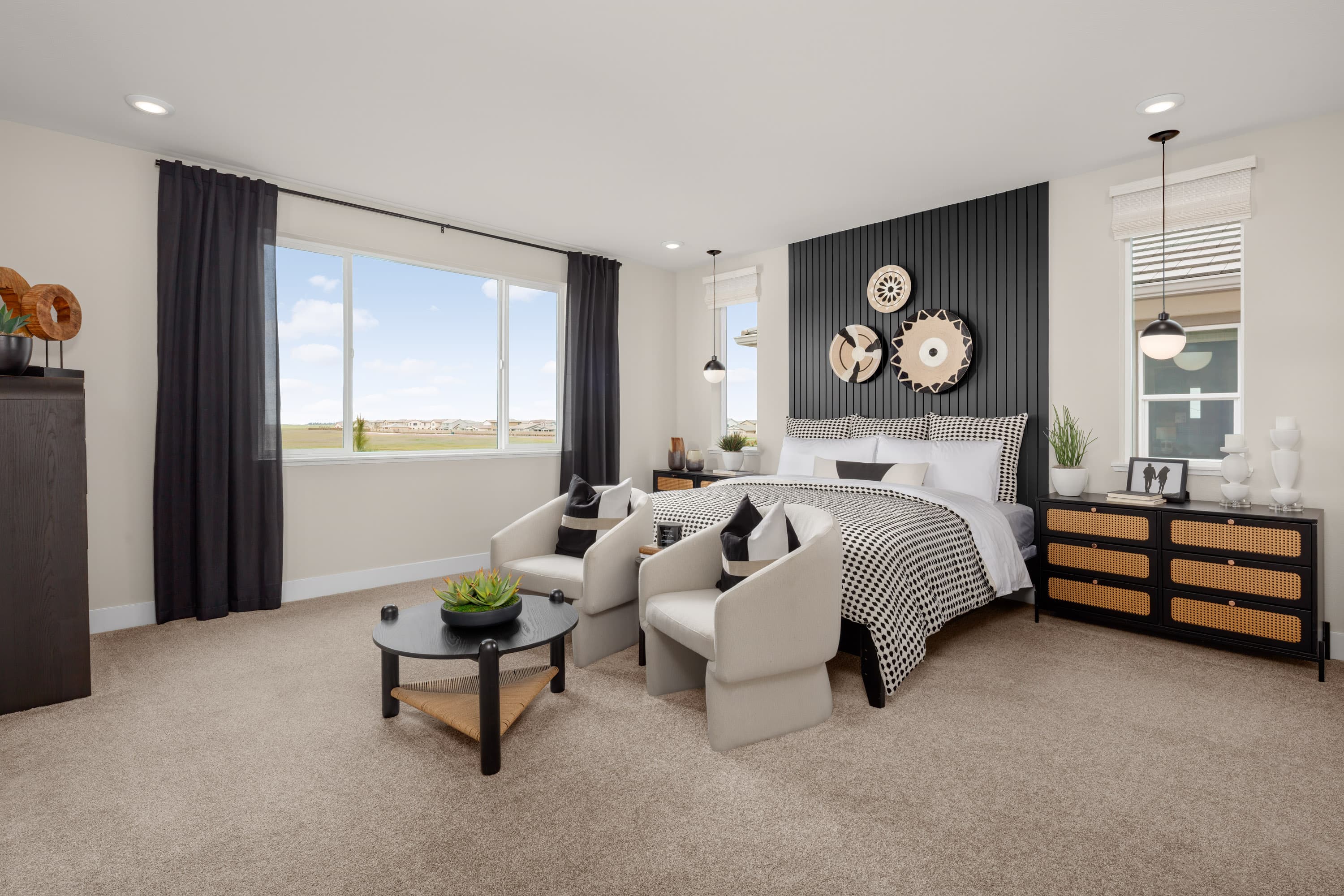 bedroom with tan carpet and charcoal accent wall