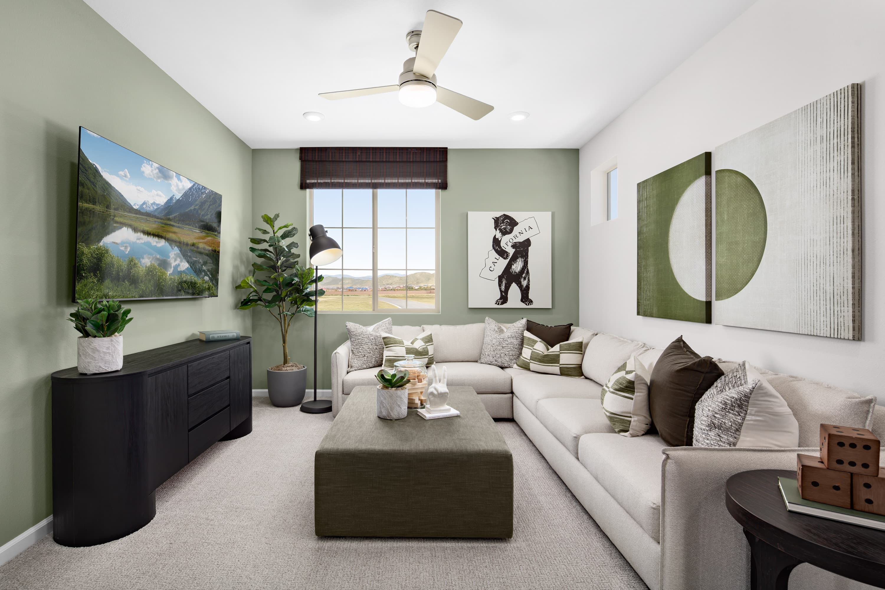 loft with sectional and tv on the wall