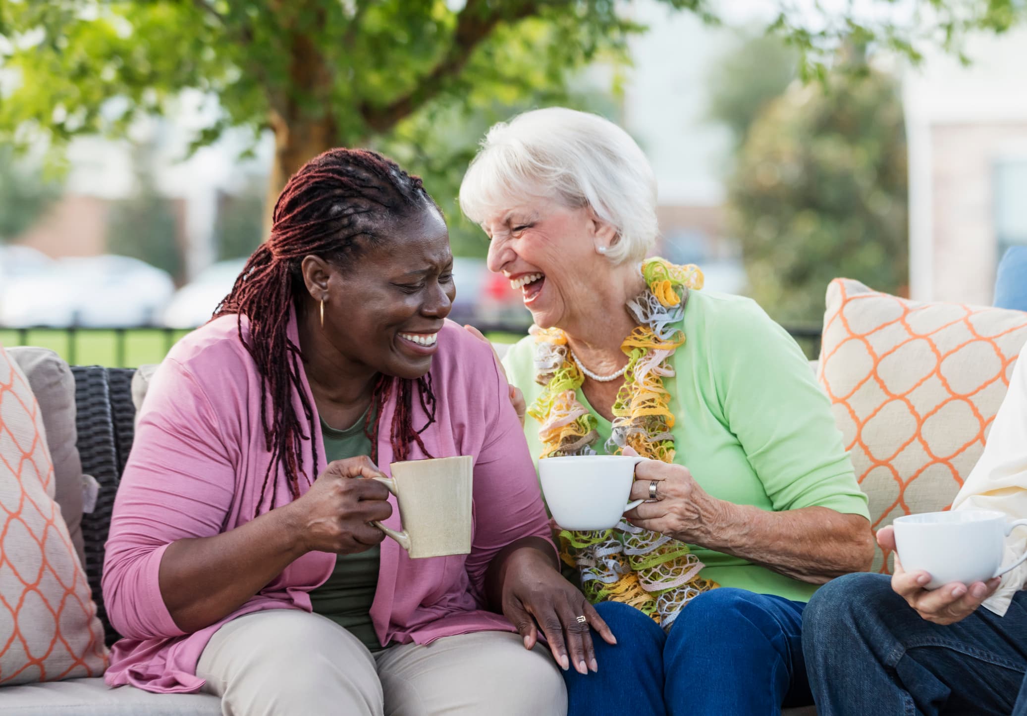 outdoor patio with 2 women laughing