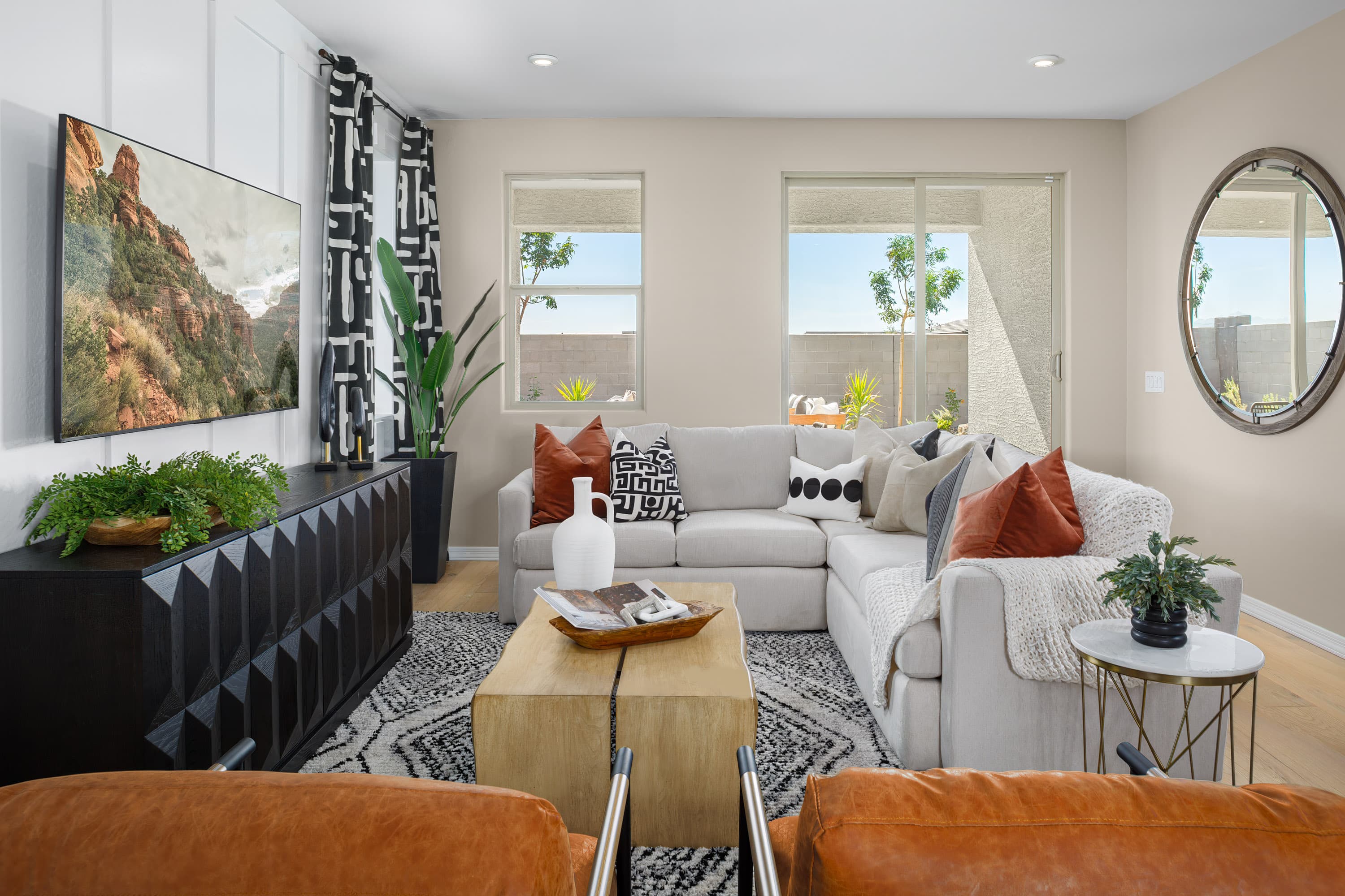 sectional with pillows and two accent chairs