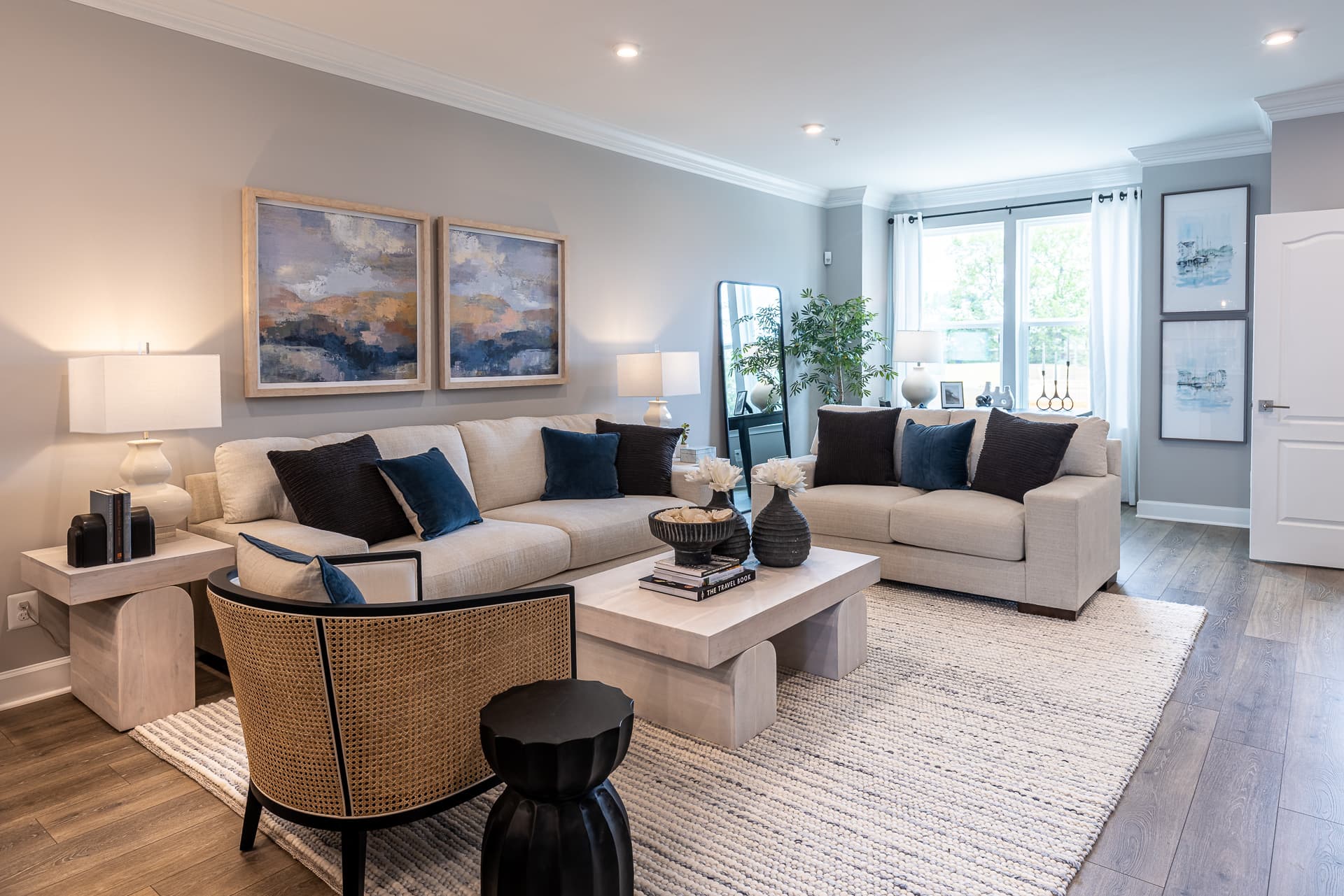 great room with ivory furniture and dark pillows