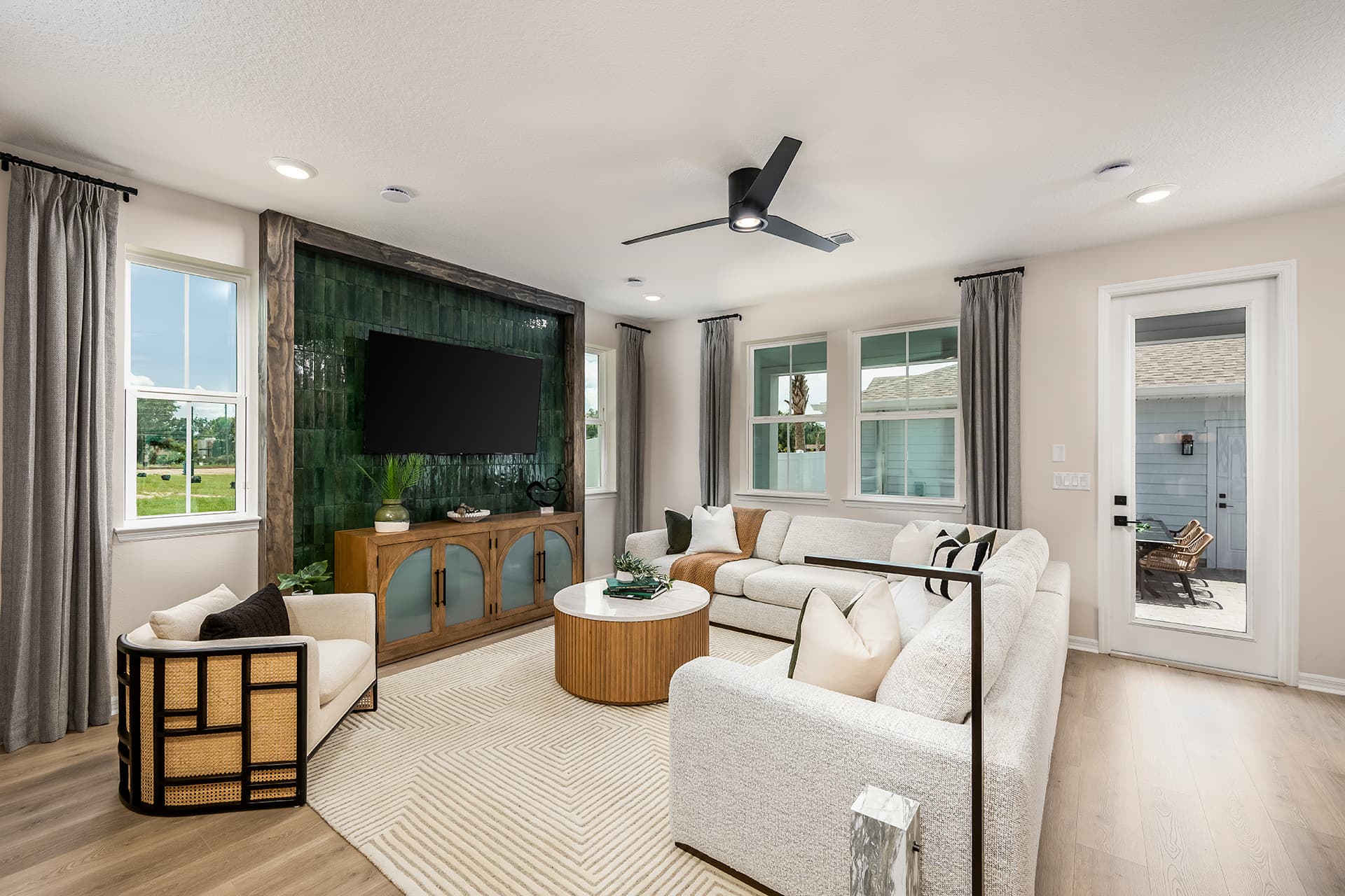 great room with cream sectional and accent chair