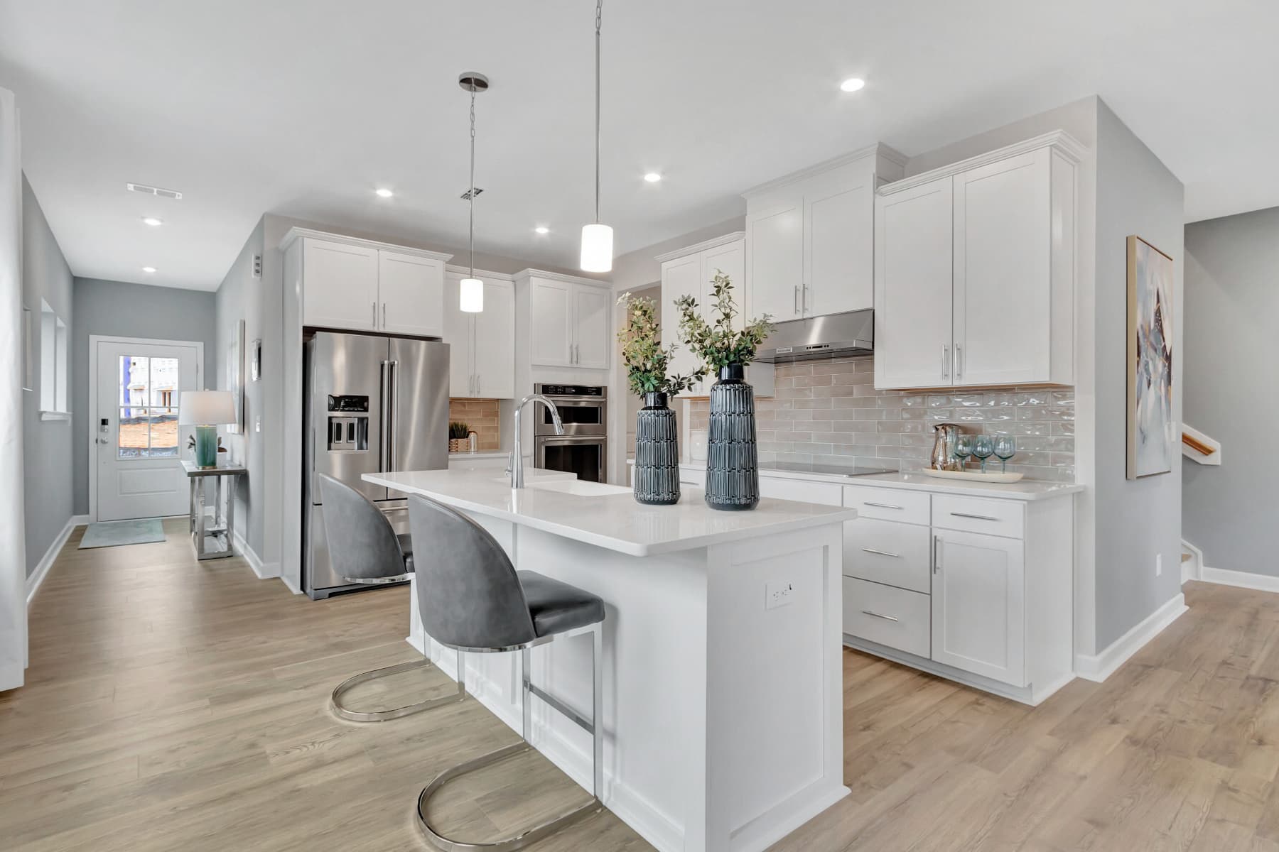 bright kitchen with island and pendant lights
