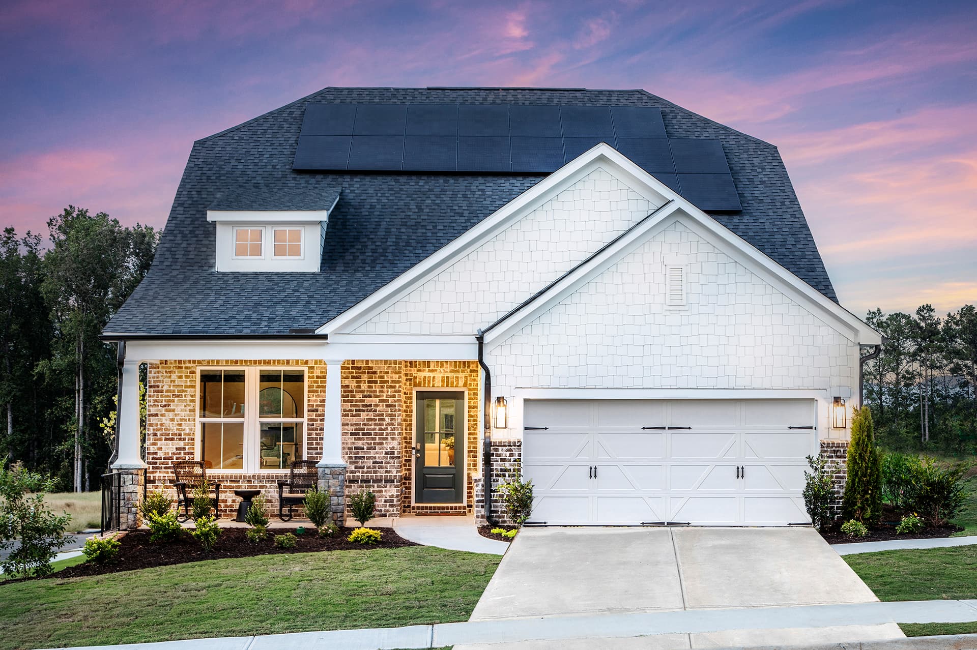 front of ranch home with white siding & brick
