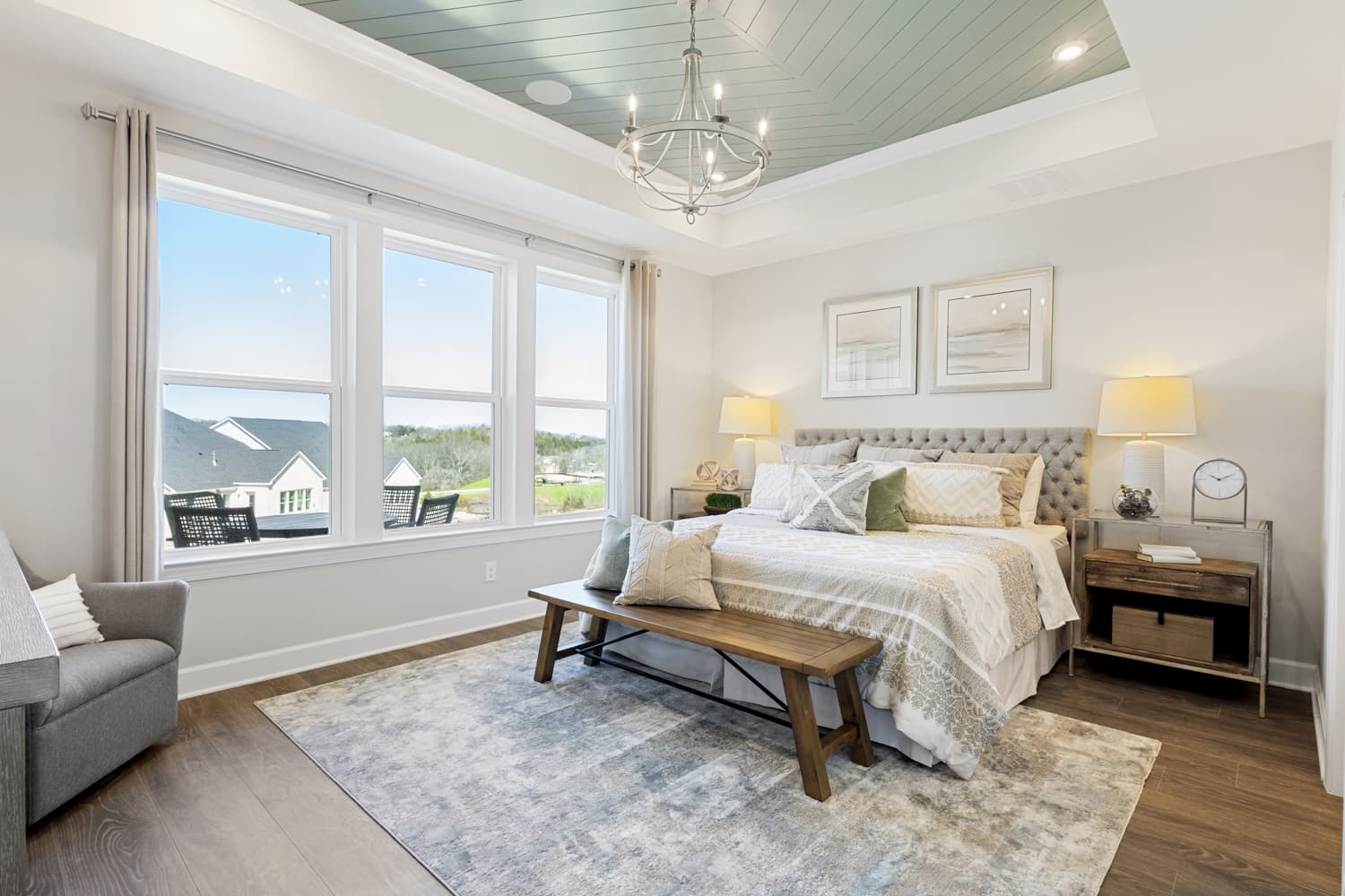 primary bedroom with a tray ceiling