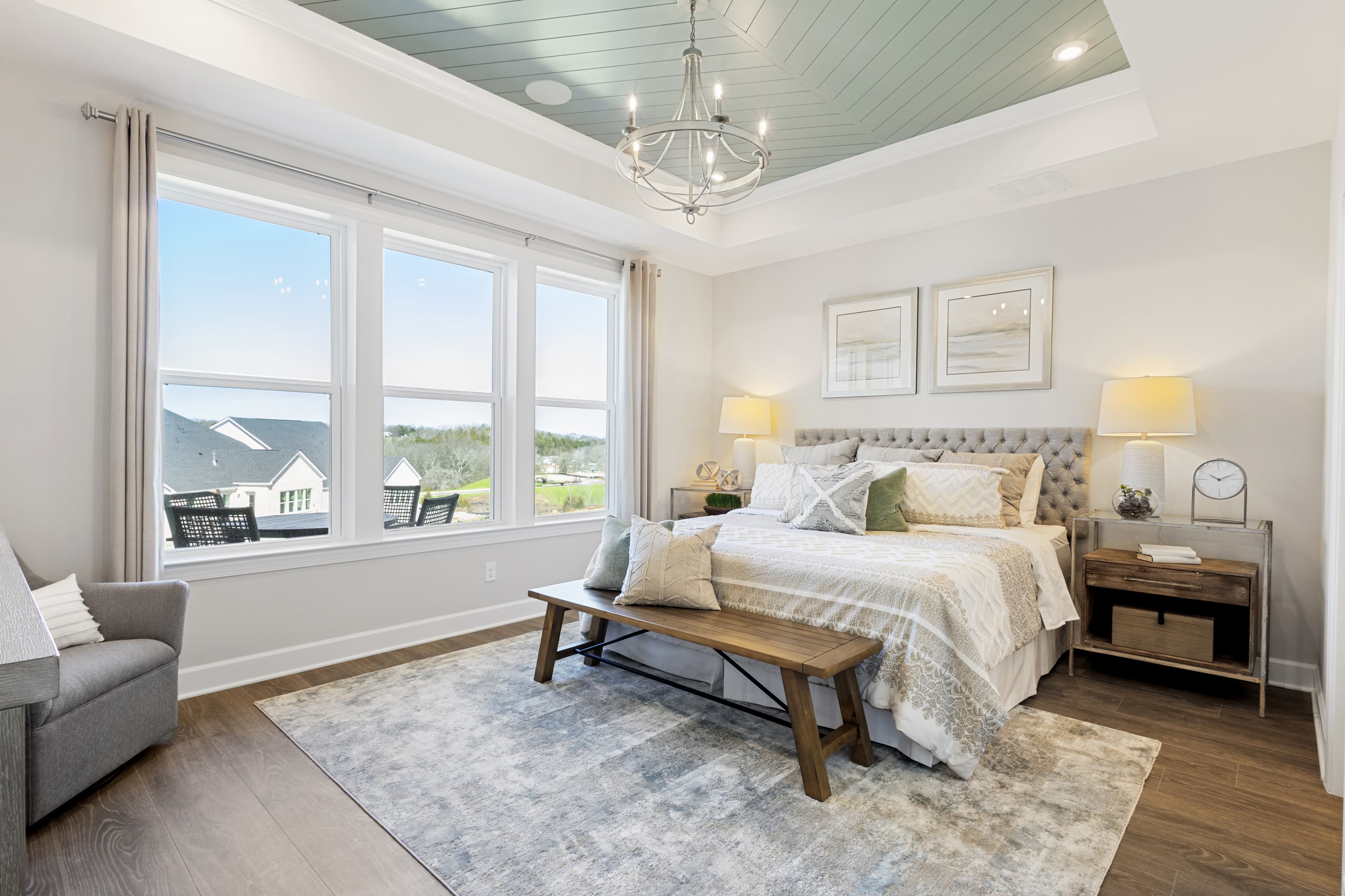 primary bedroom with bed, nightstands, and windows