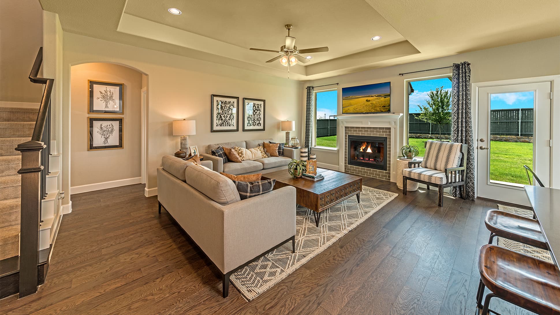 open great room with wood floors and ceiling fan