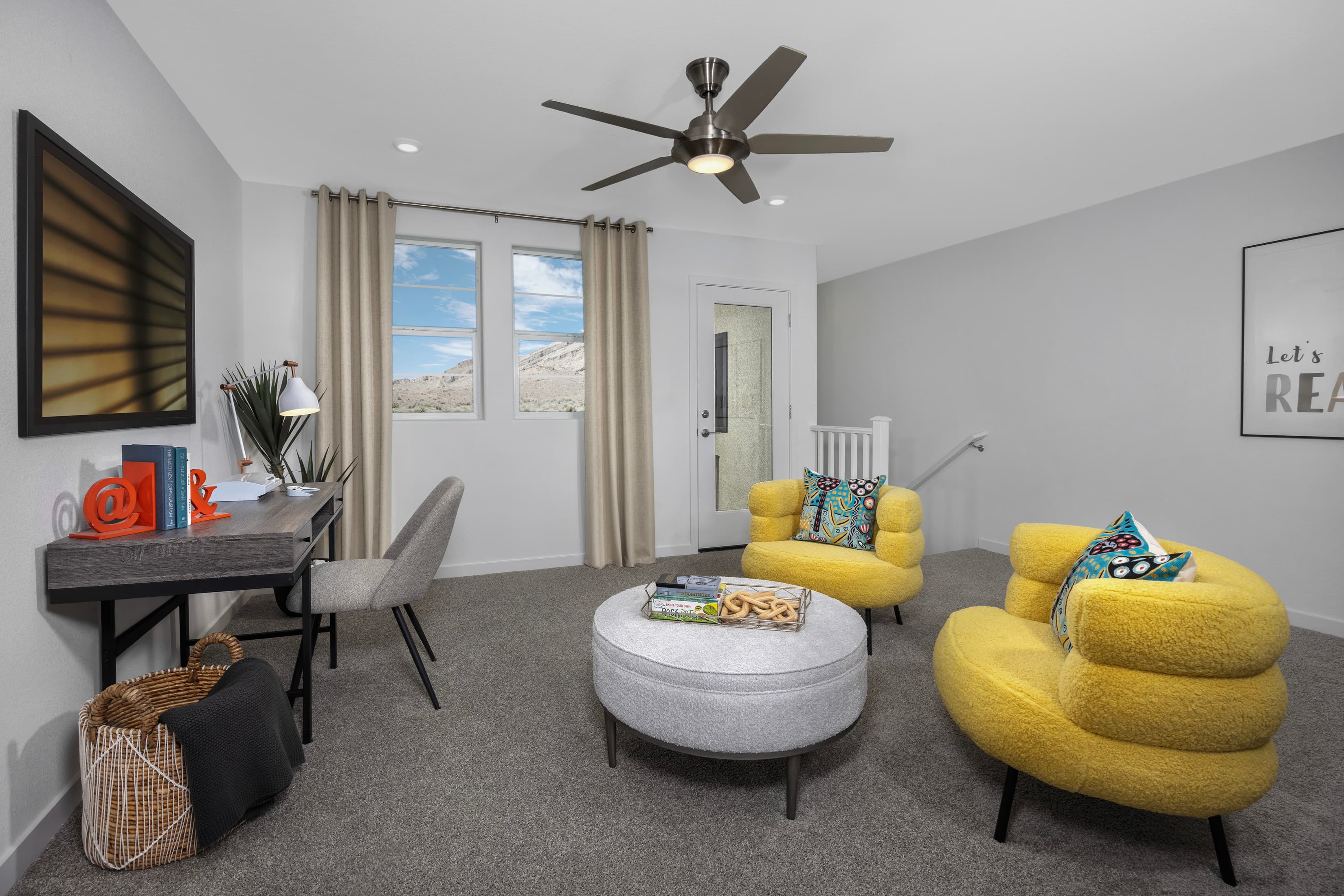 loft with two yellow chairs and table