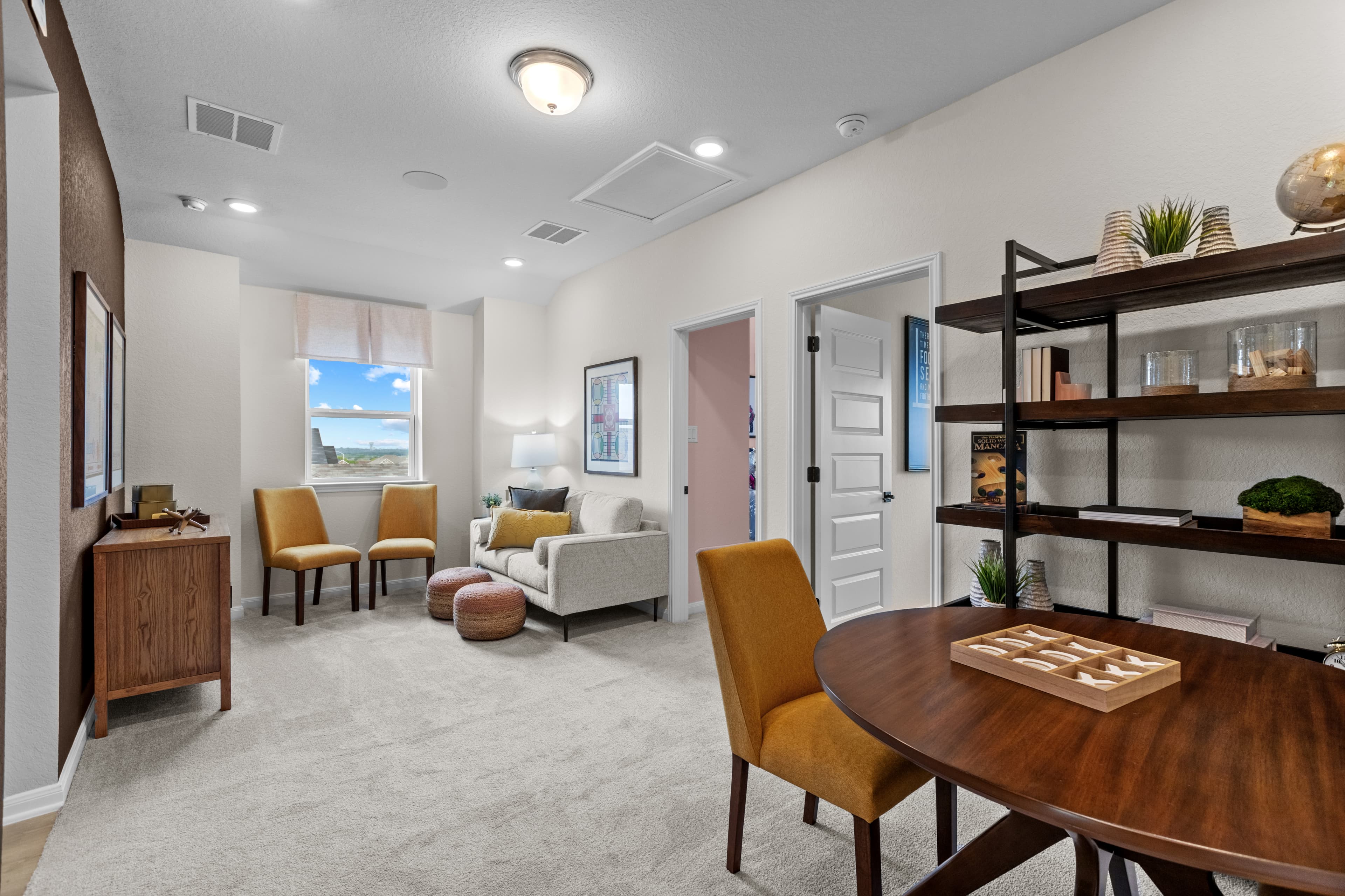 loft with carpet, couches & a table with games