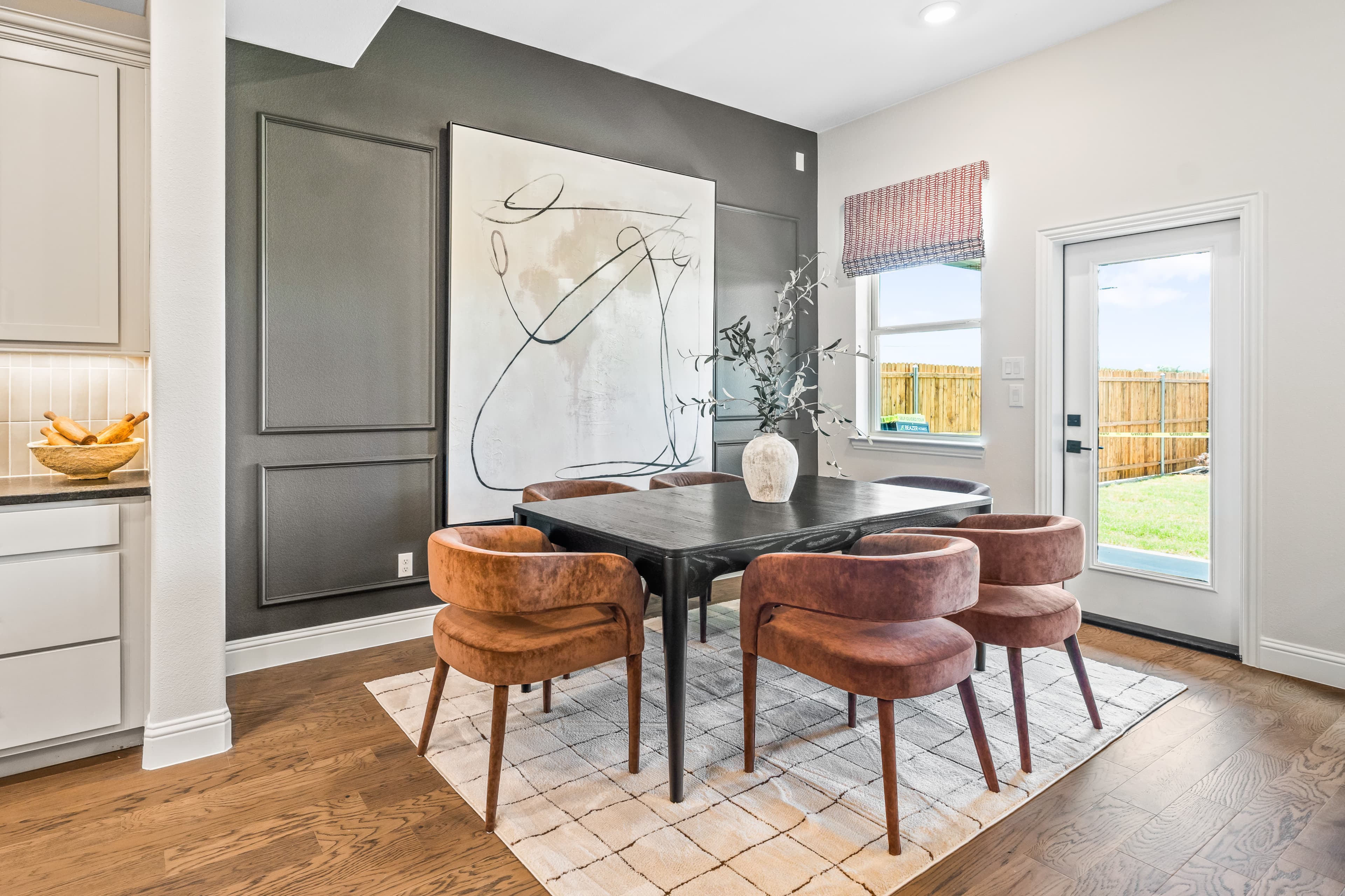 open dining area with gray accent wall