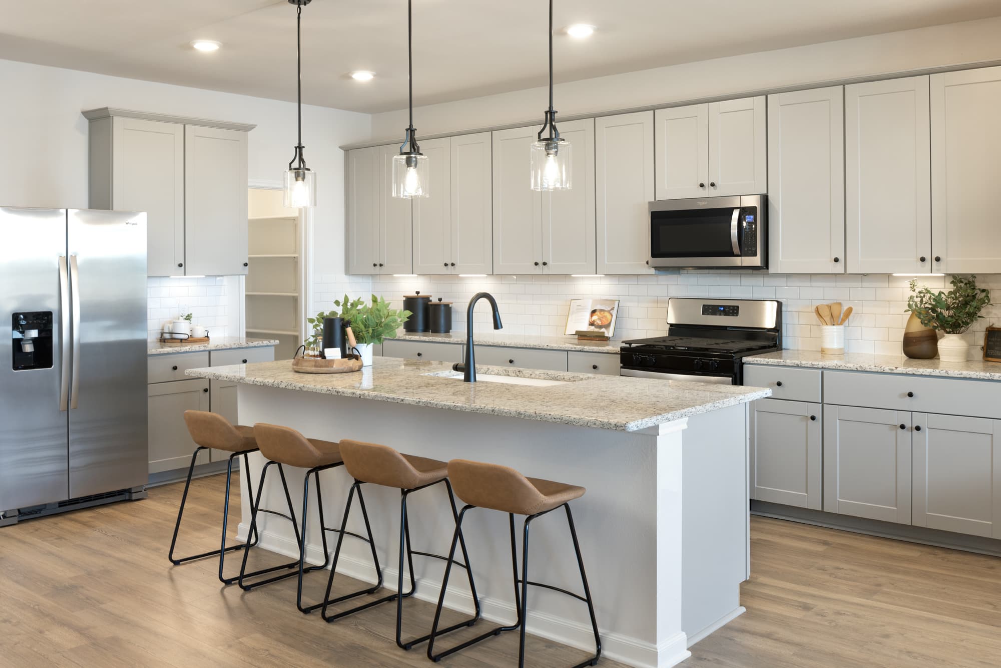 kitchen with granite countertops & brown barstools