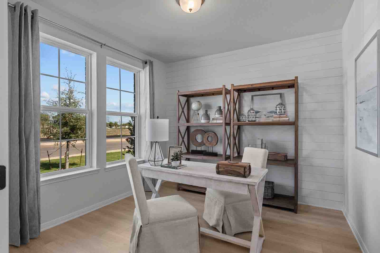 study with a desk, windows & wooden displays 