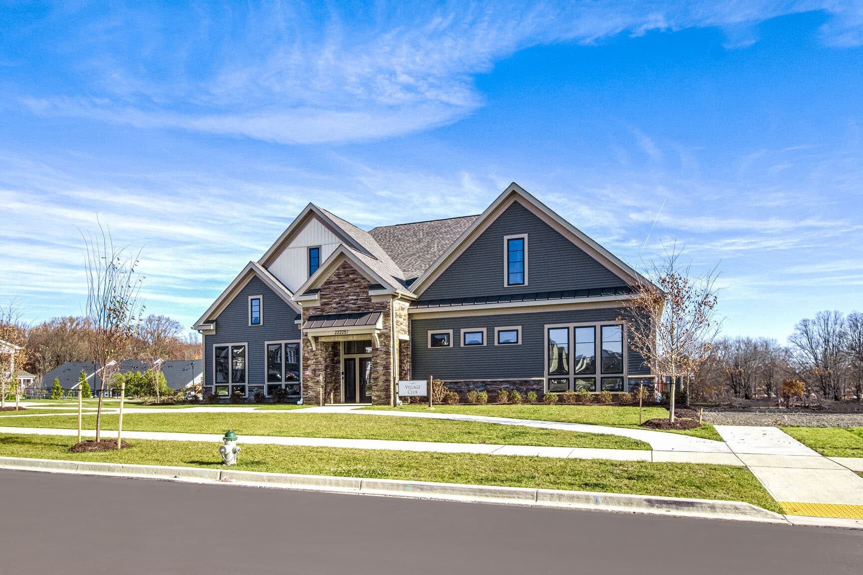 brand-new clubhouse with blue siding and stone