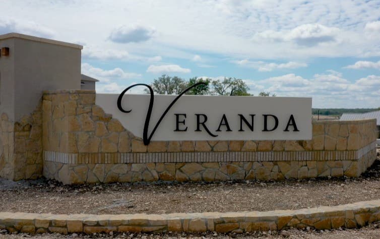 community entrance with a stone sign