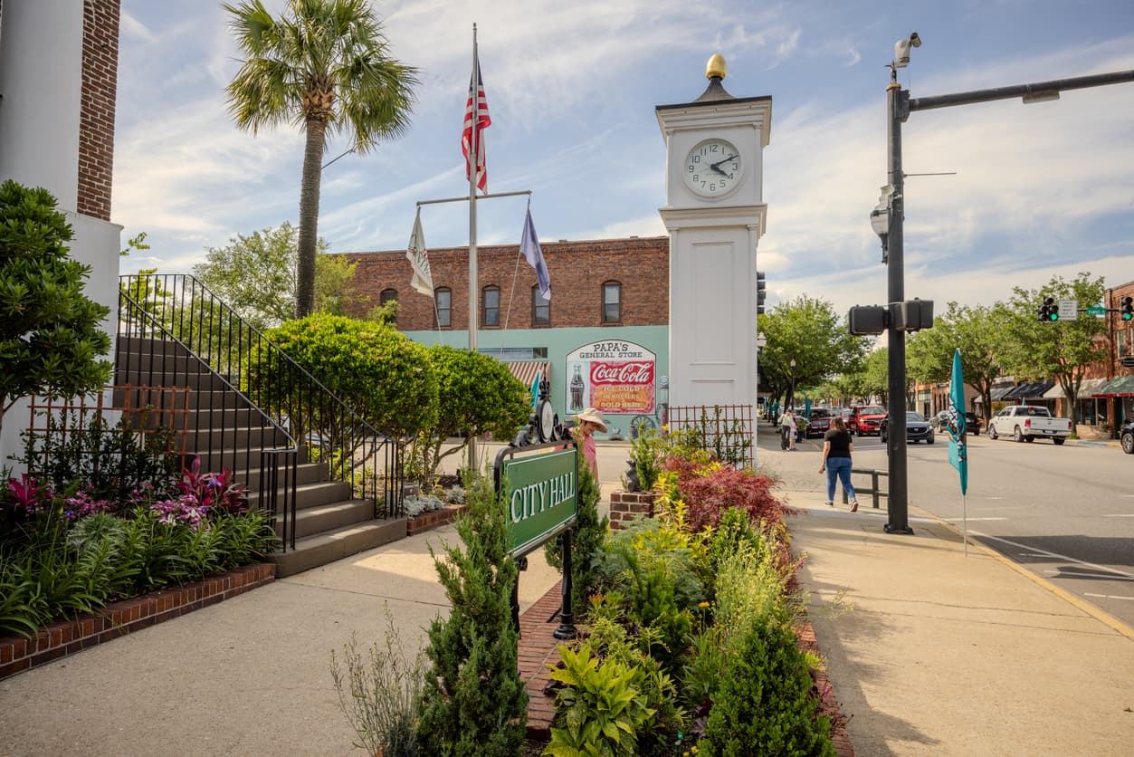 Downtown historic Conway with sidewalks, greenery and people walking.  