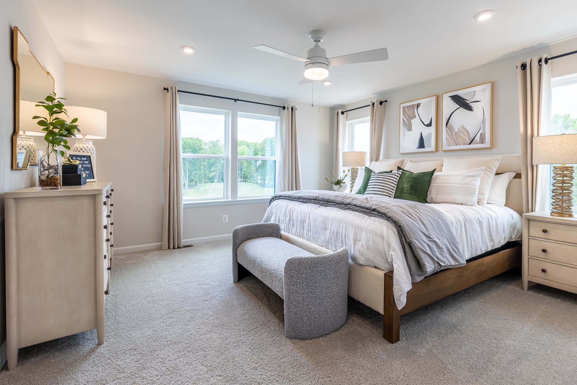primary suite with a king sized bed and carpet