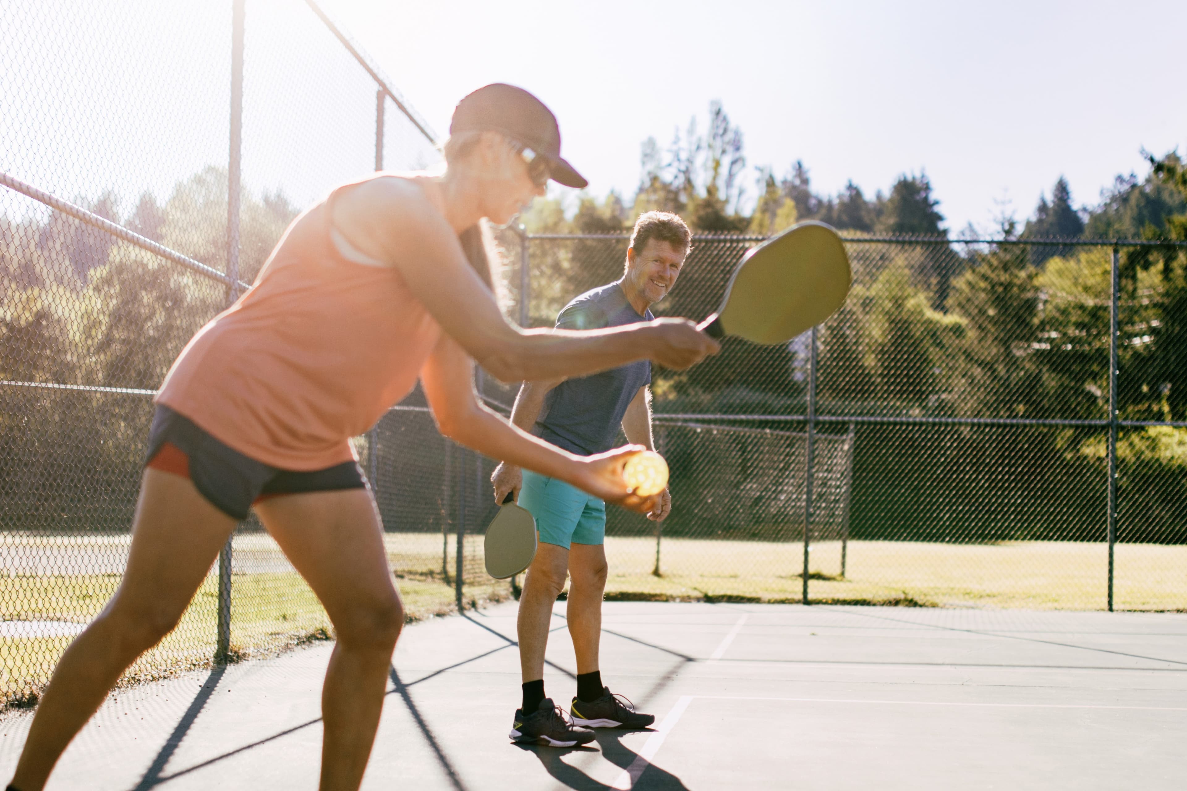 man and woman playing pickle-ball