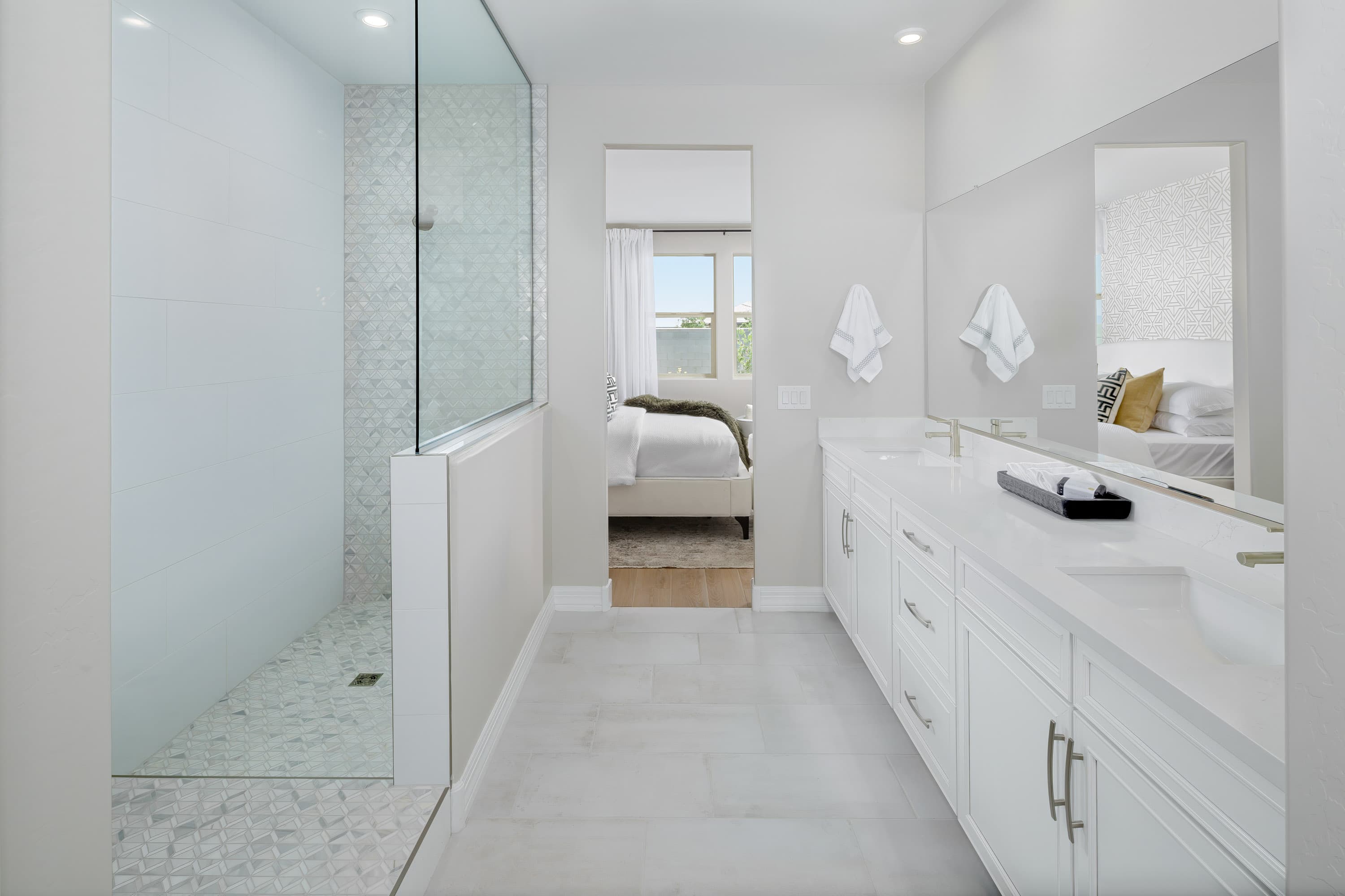 white tile flooring in shower with white cabinets