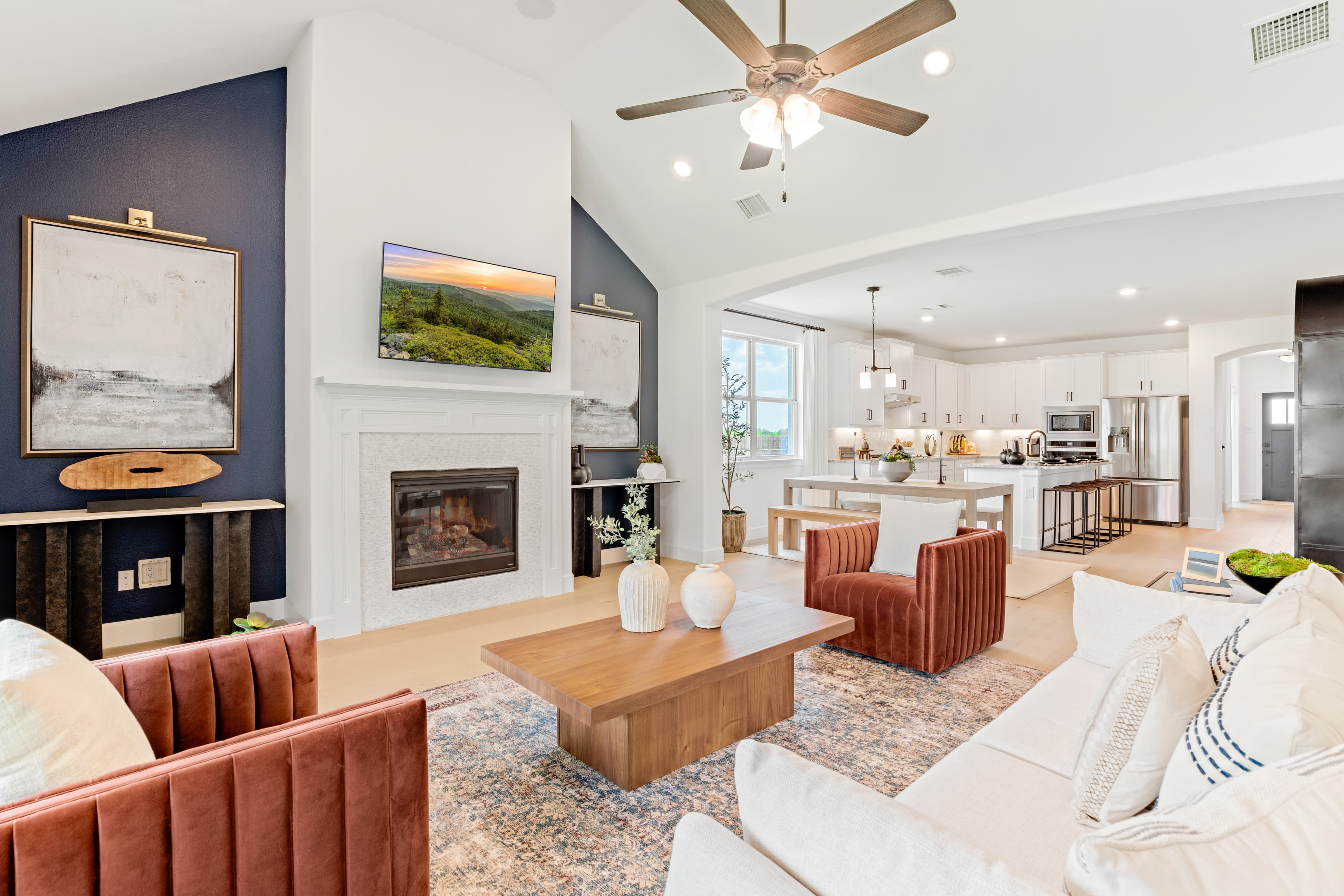 great room with wood floors and soaring ceilings 