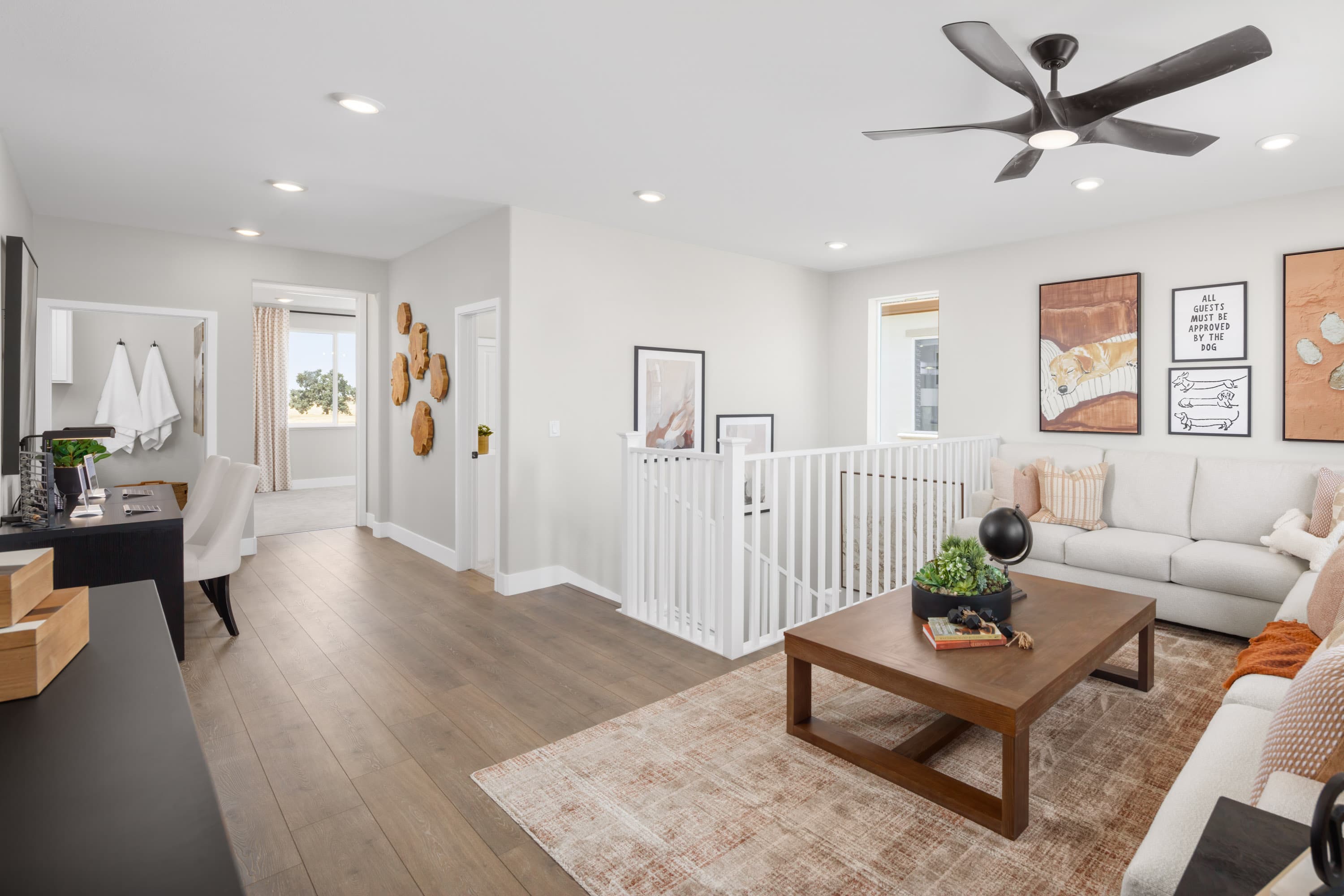 loft with wood floors, and white sectional sofa