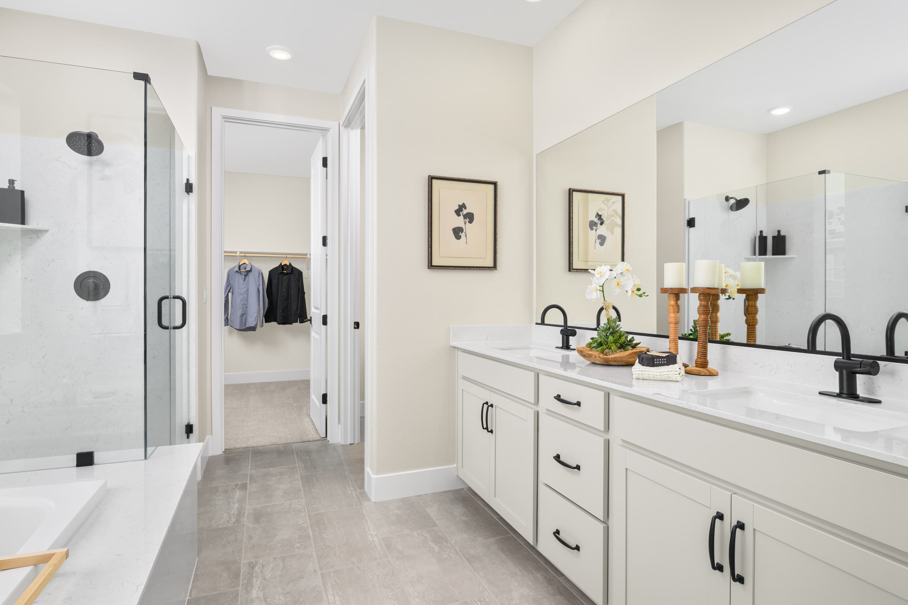 bathroom with dual vanity sinks and white cabinets