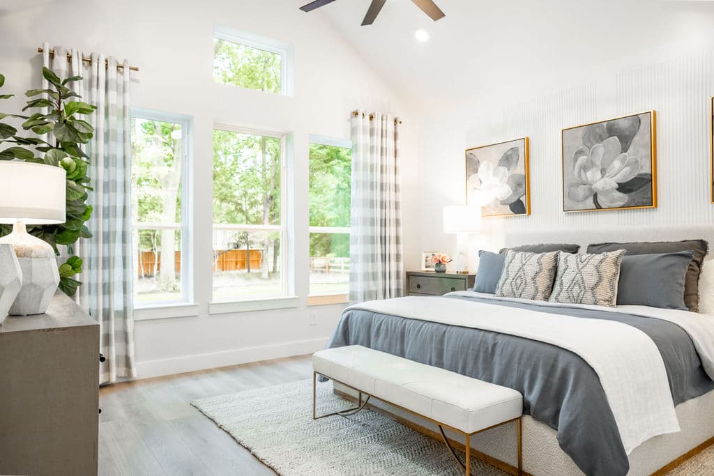 bedroom with striped bedding and 4 windows