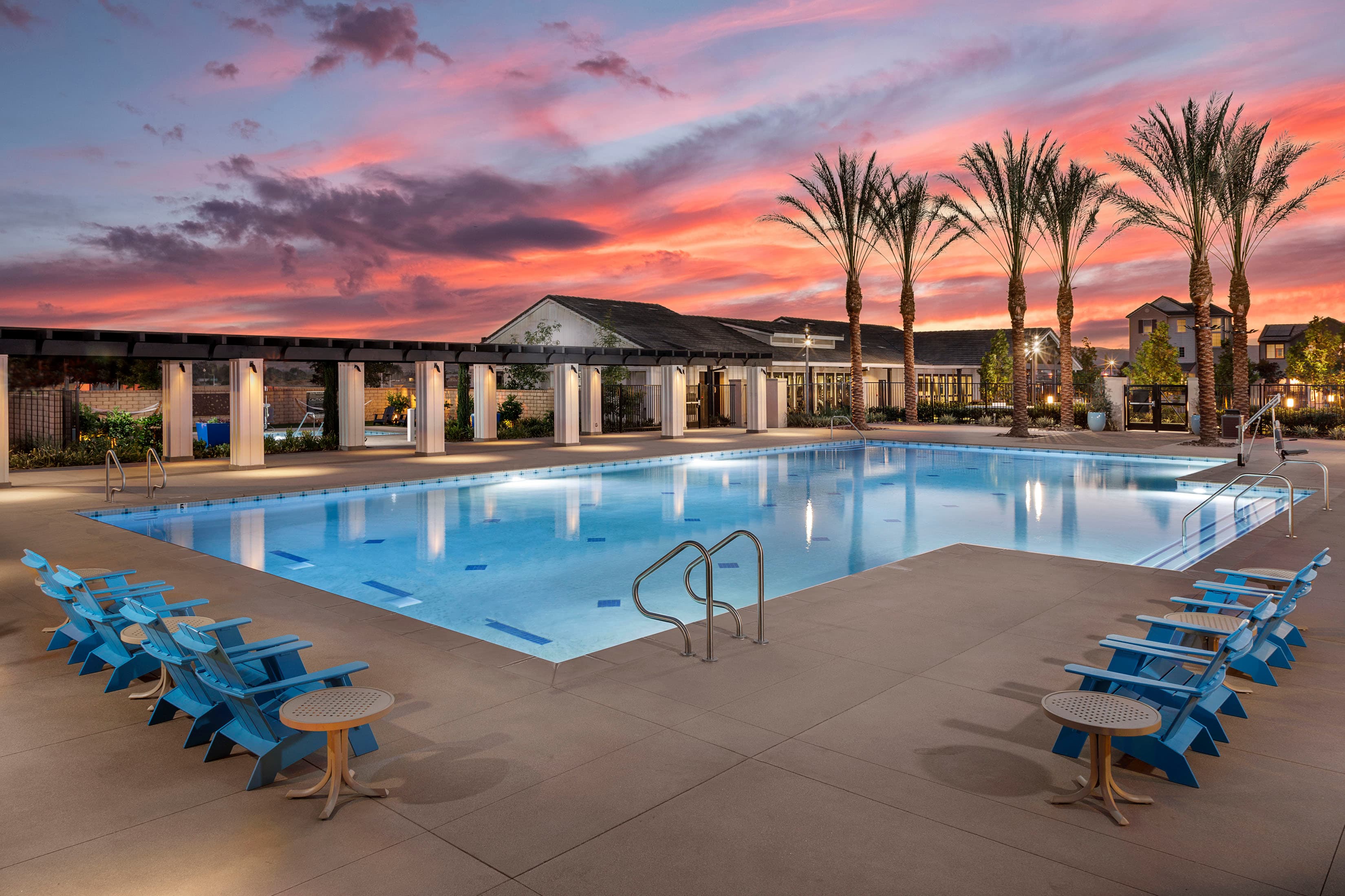 large pool with chairs and table around it 
