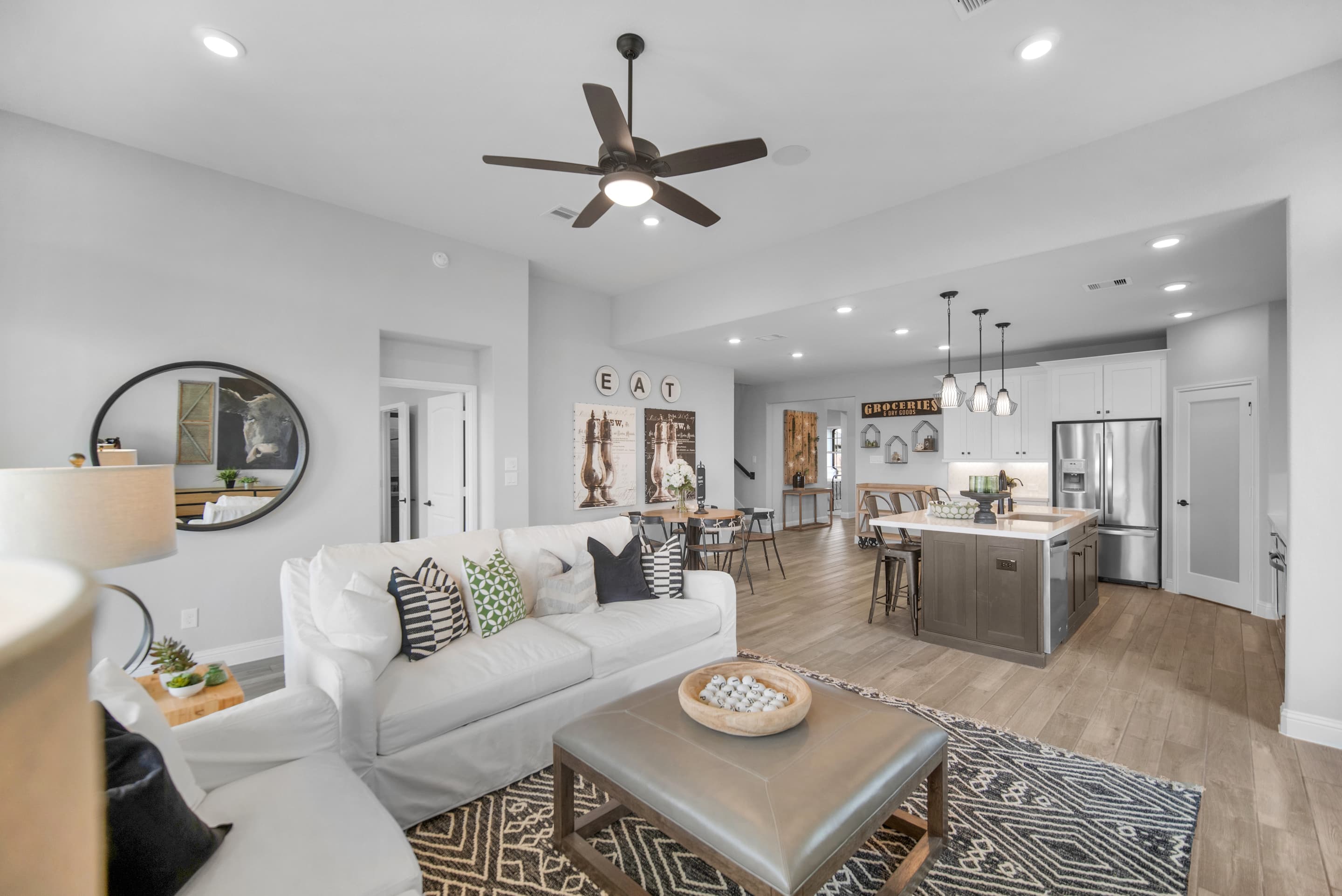 great room with wood-like tile and ceiling fan