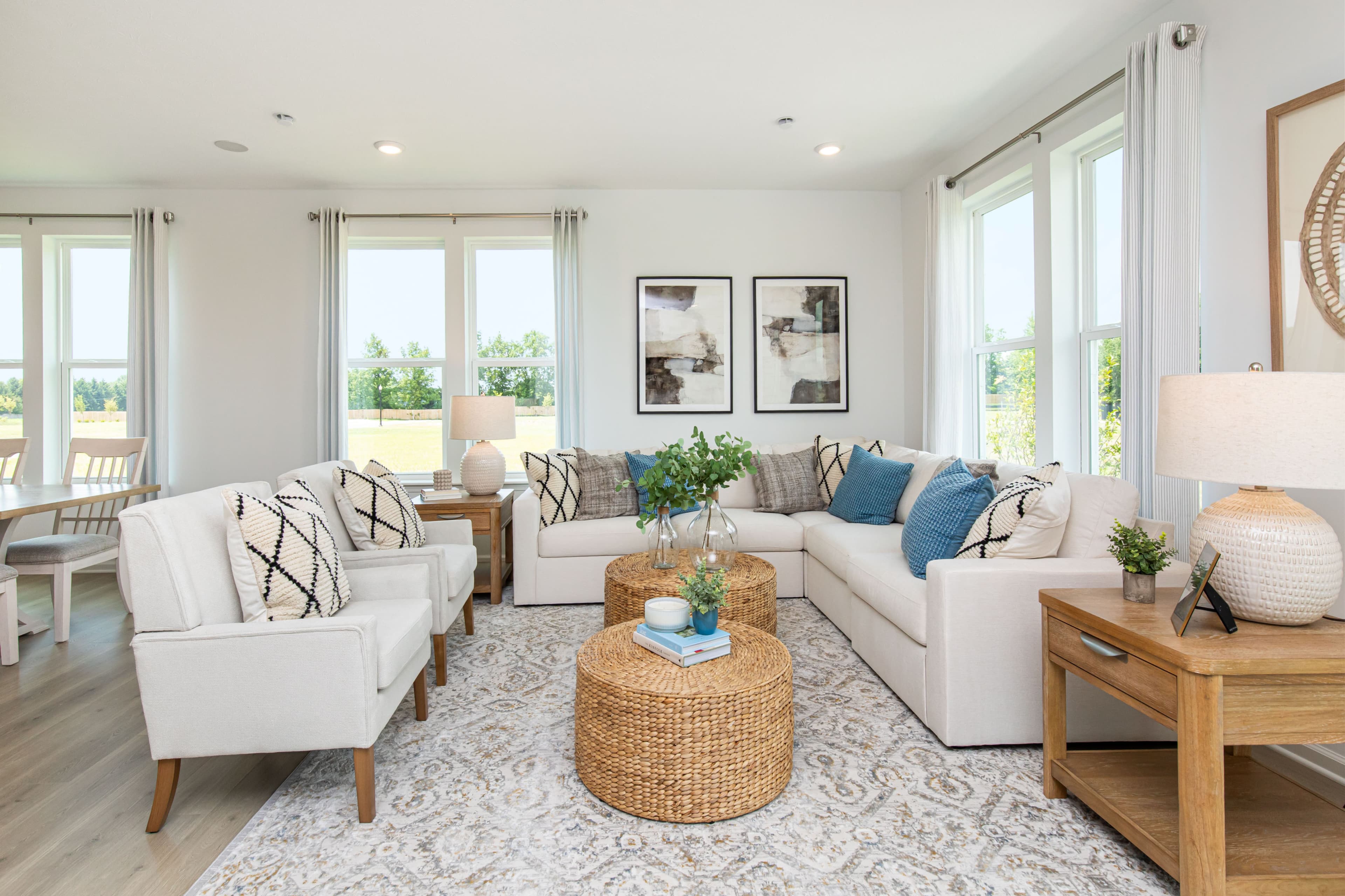 great room with white couches and windows