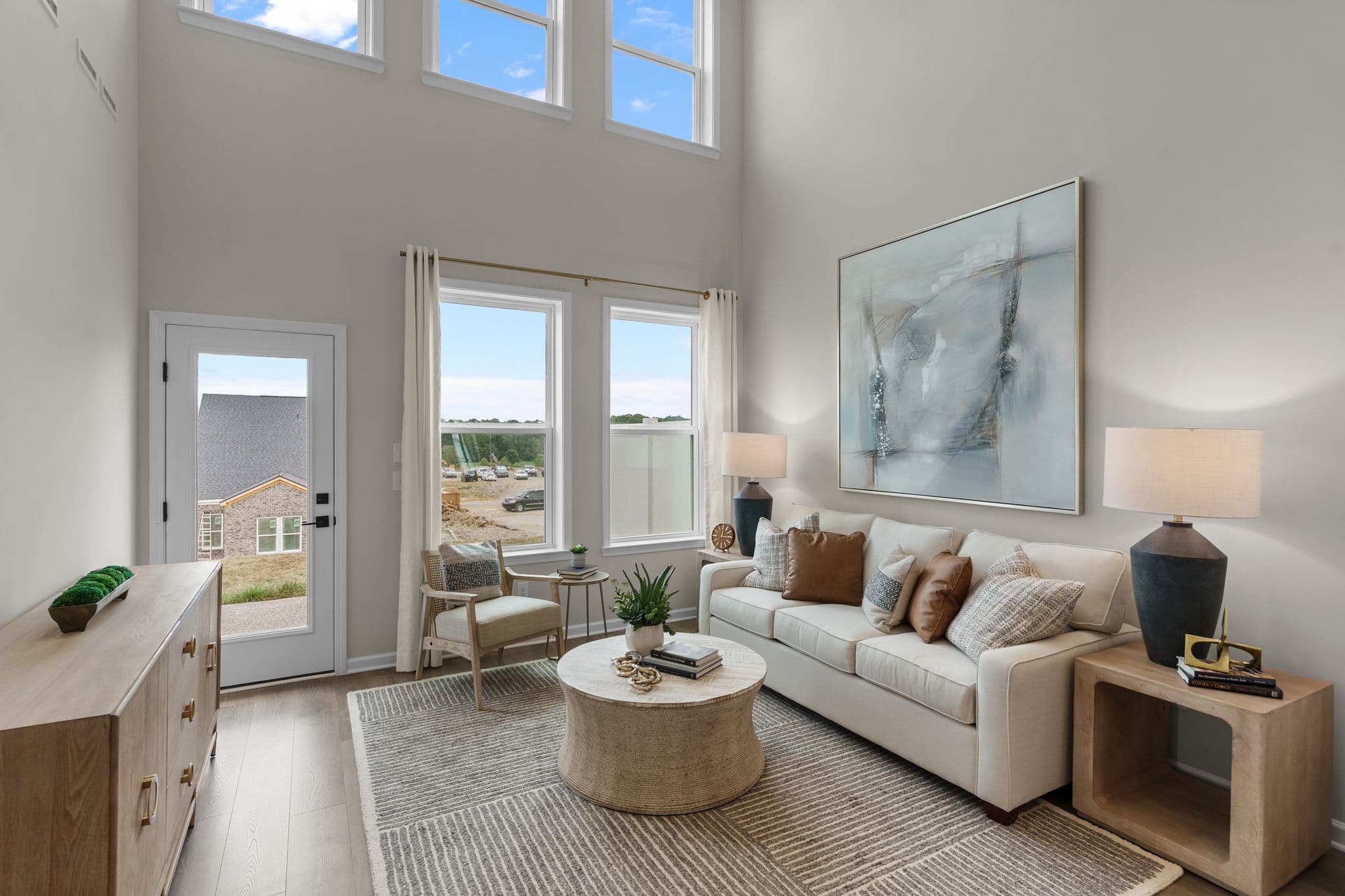 great room with two-story ceiling and furniture
