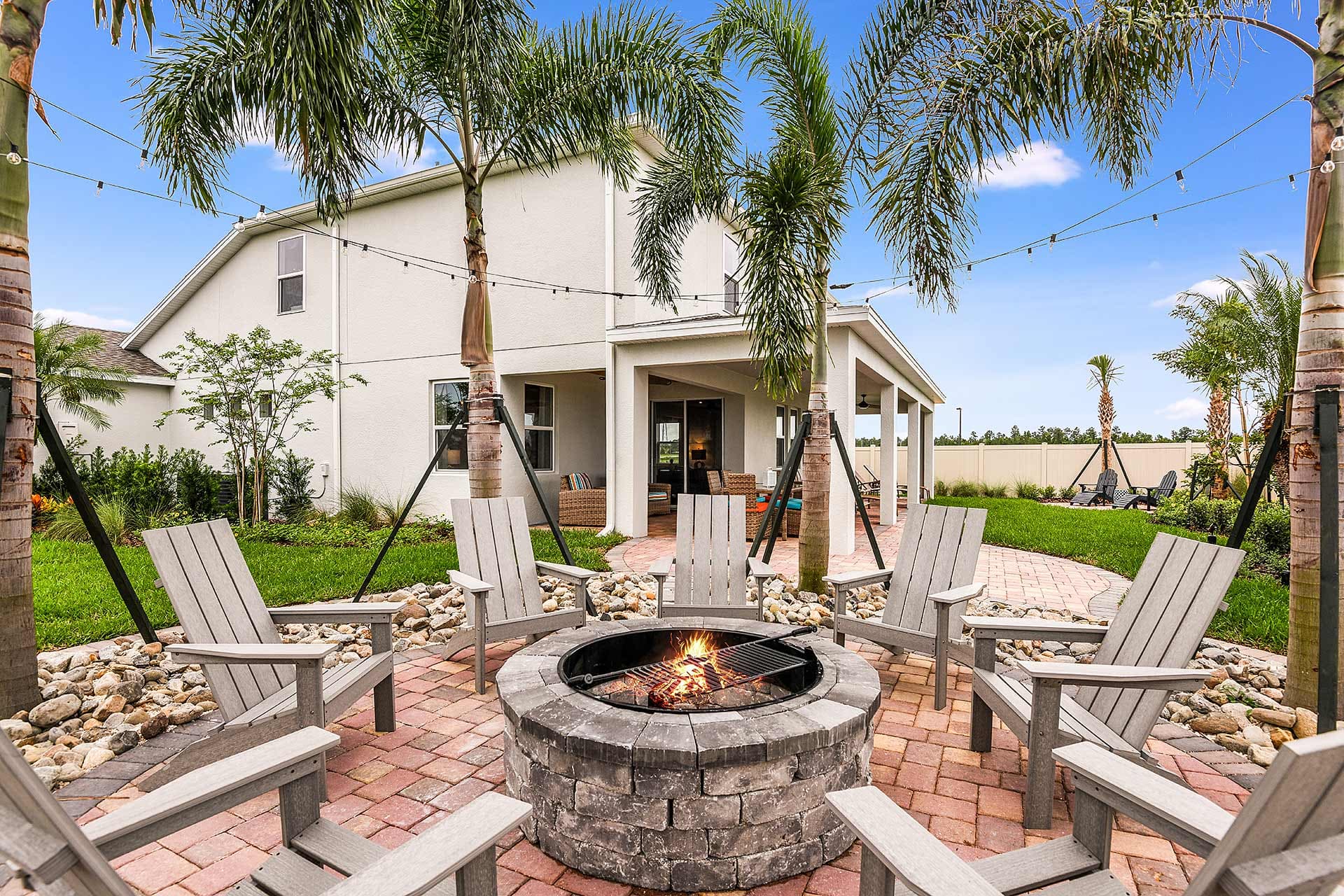 backyard oasis with fire pit and palm trees