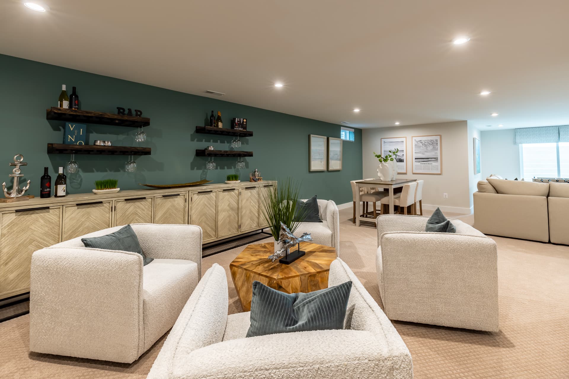 large basement with couches and a game table