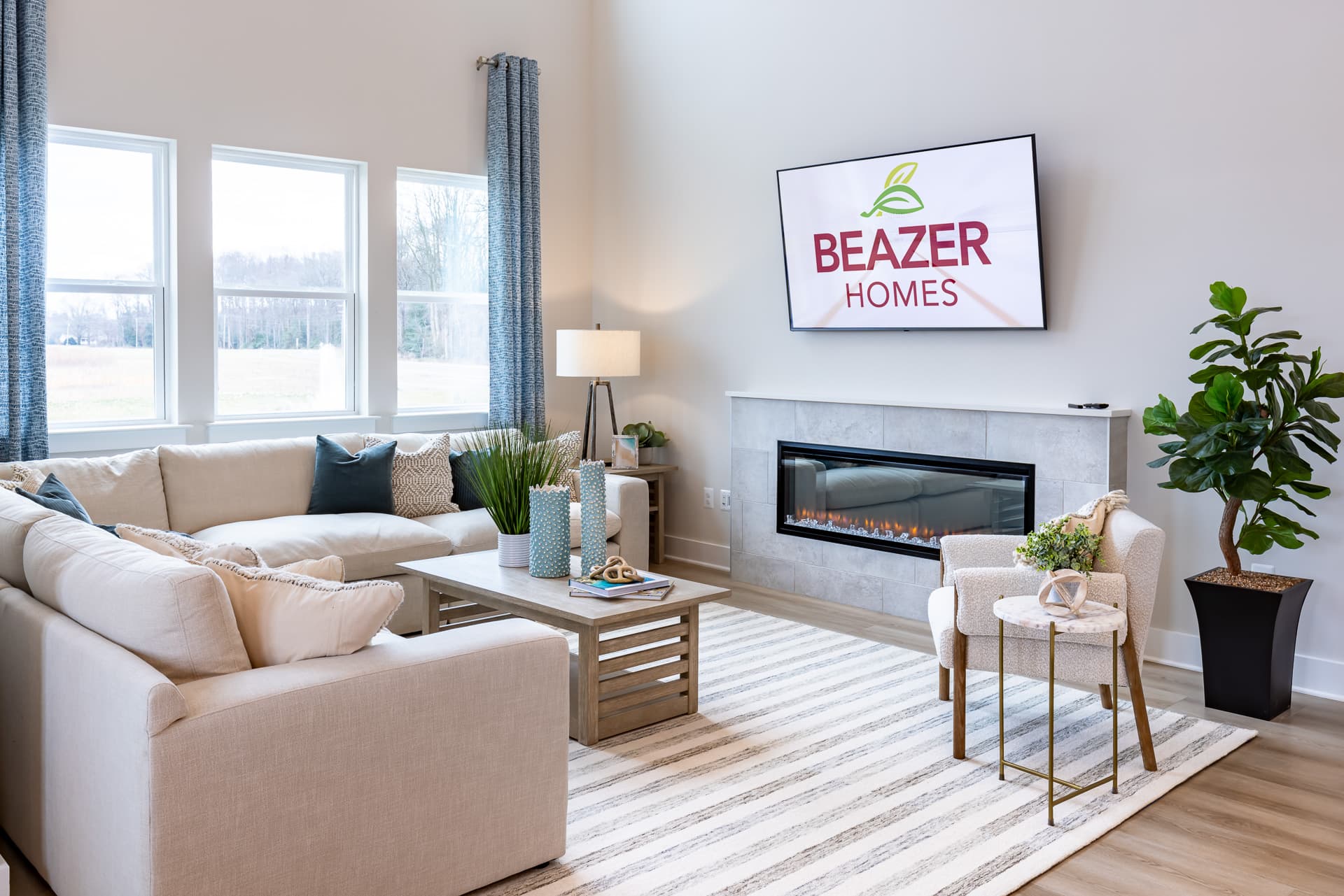 great room with an electric fireplace and couches