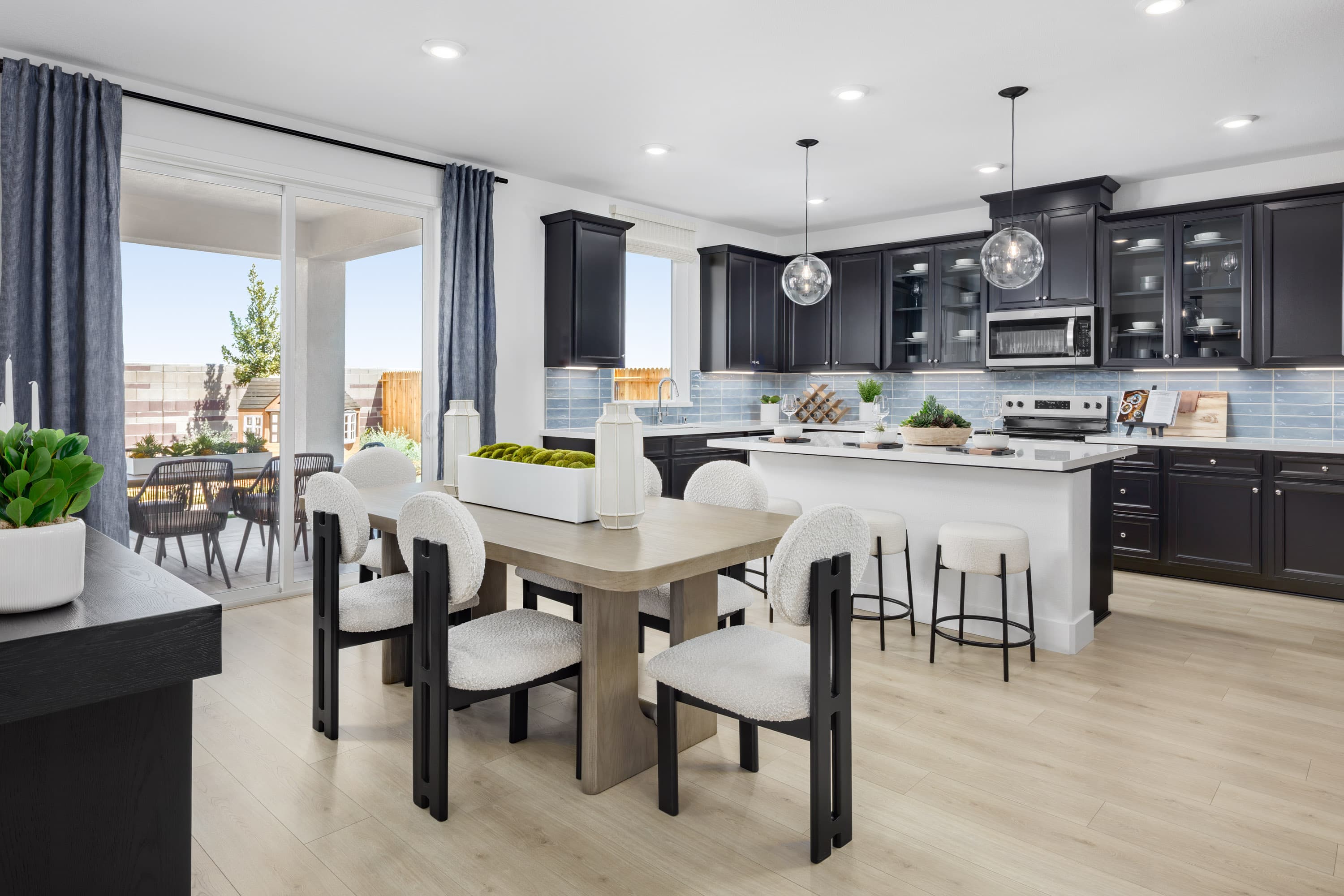 kitchen with light wood floors & black cabinets