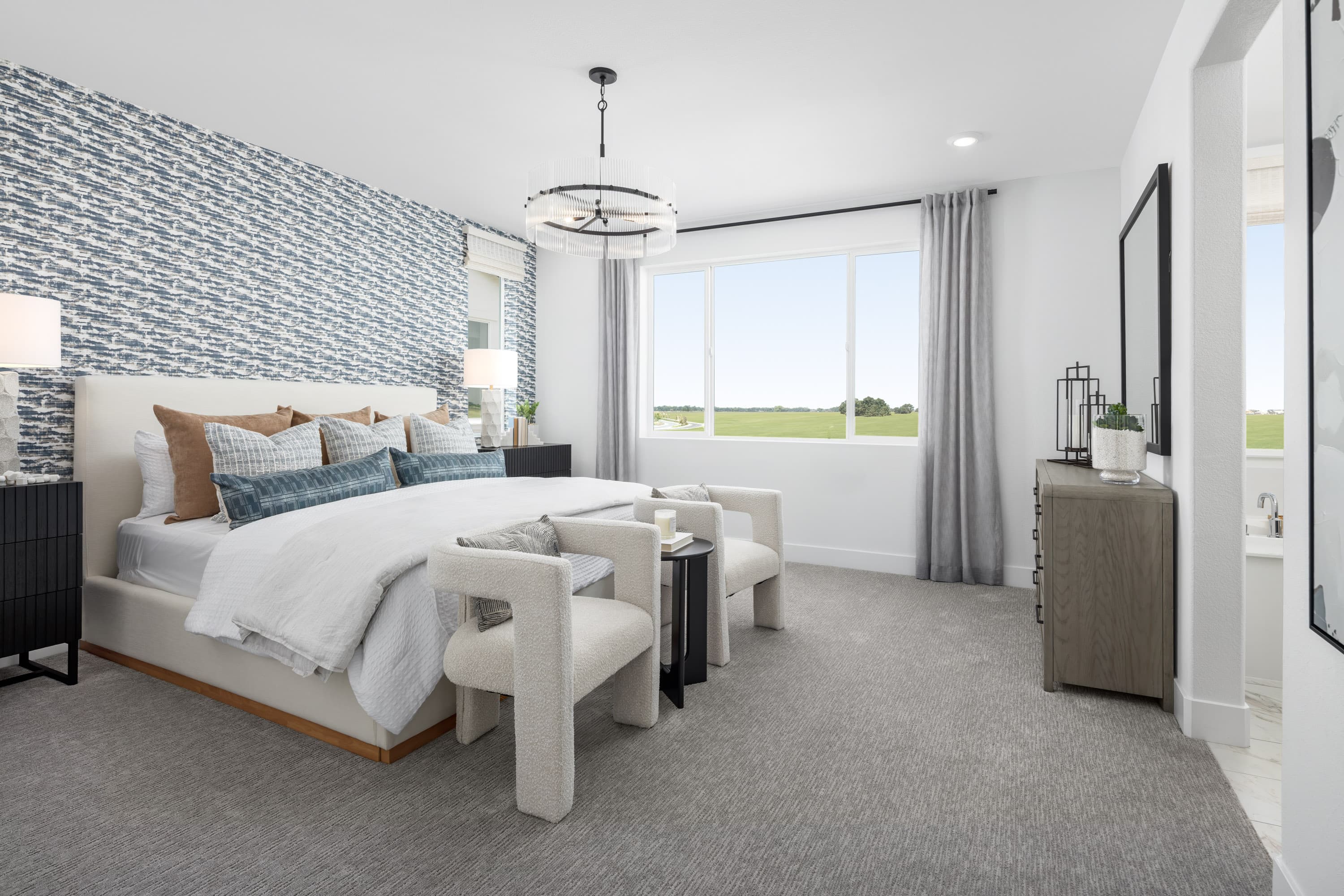 bedroom with white bed, and large window