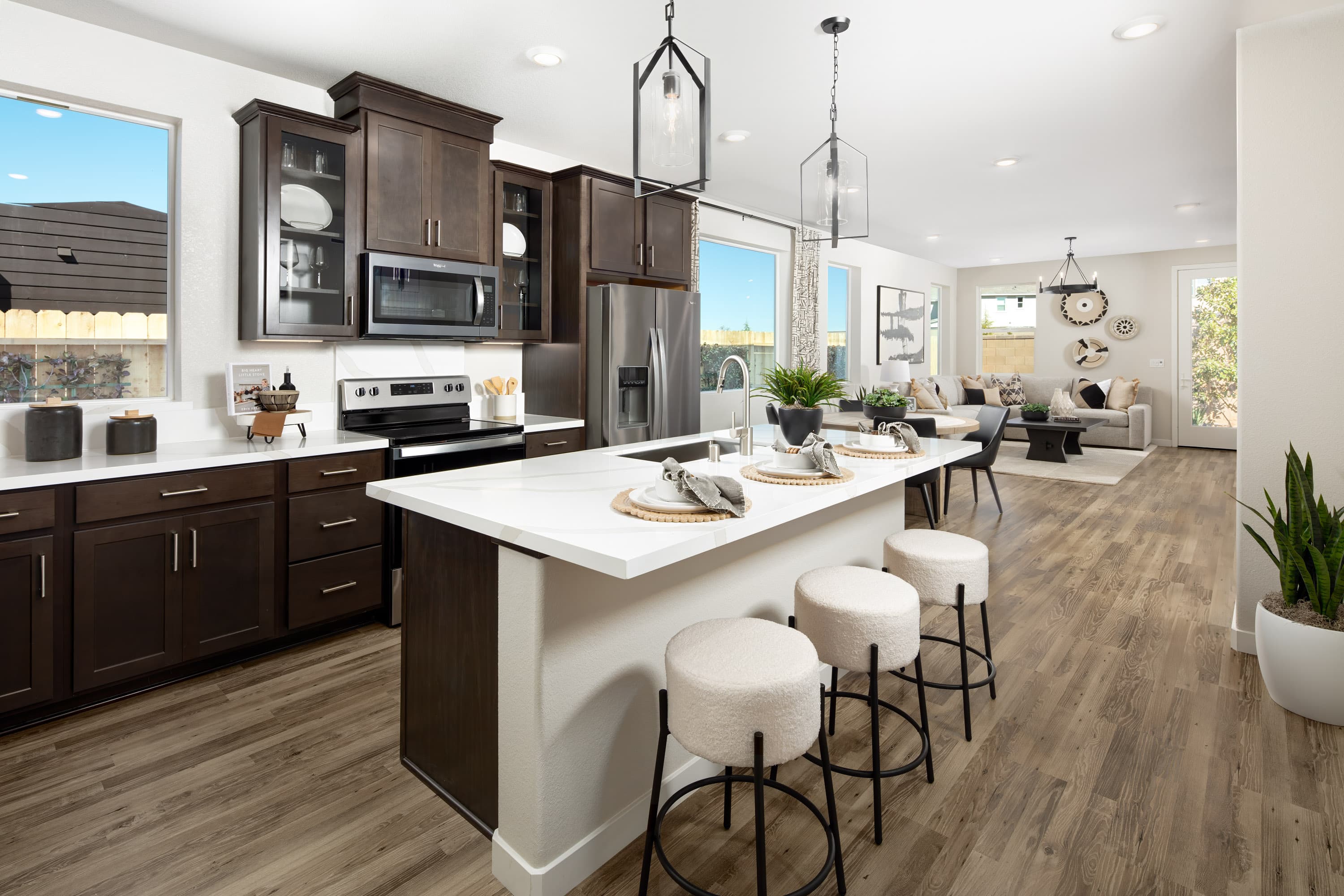 kitchen with espresso cabinets, and white counters