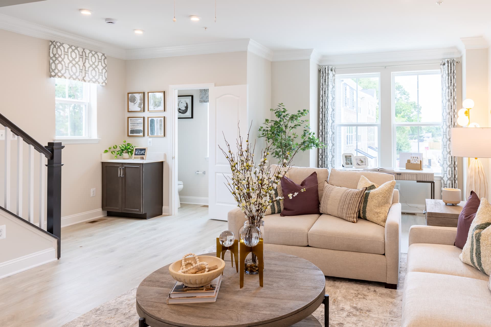 great room with large windows and stairs